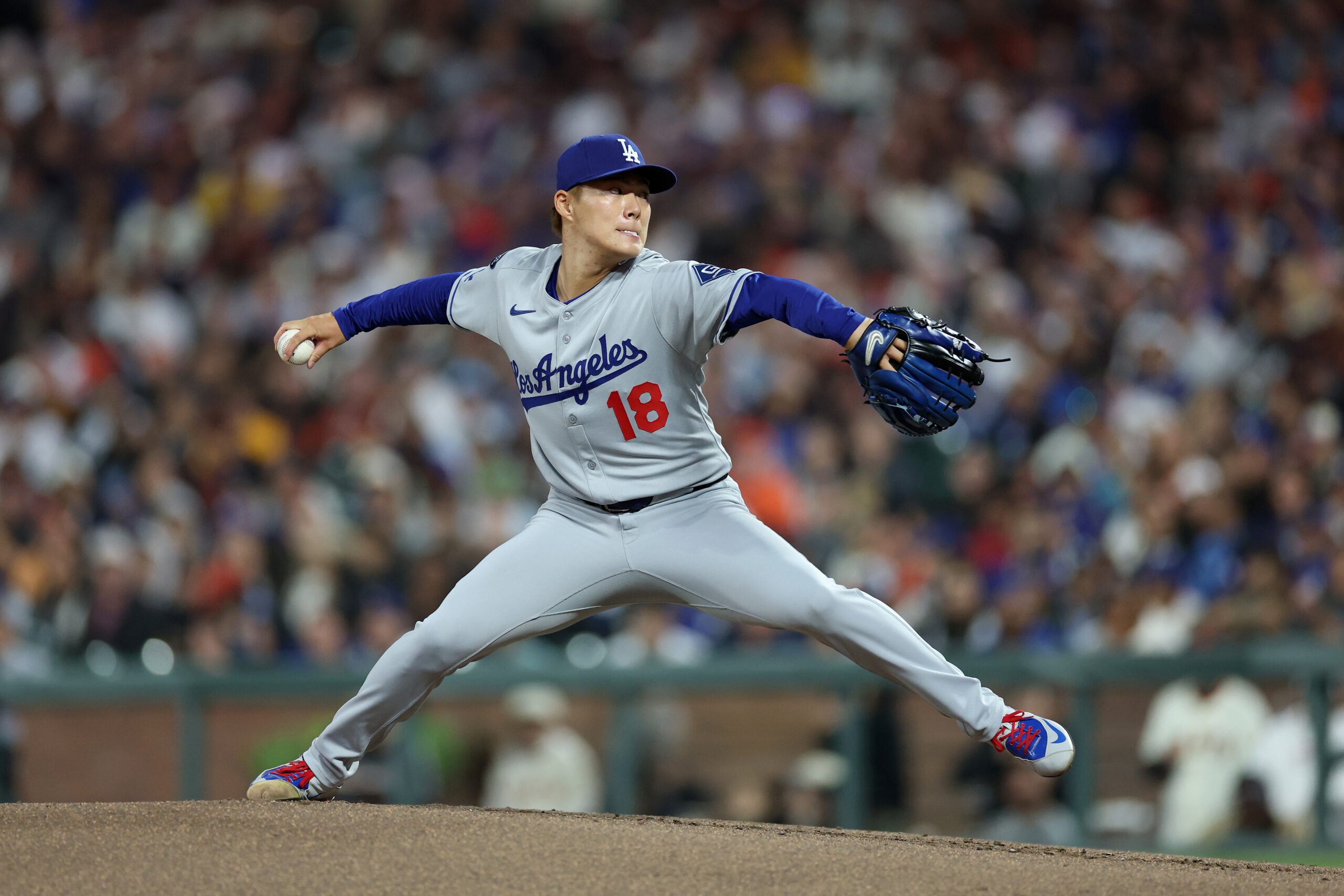 Dodgers starting pitcher Yoshinobu Yamamoto throws to the plate during...