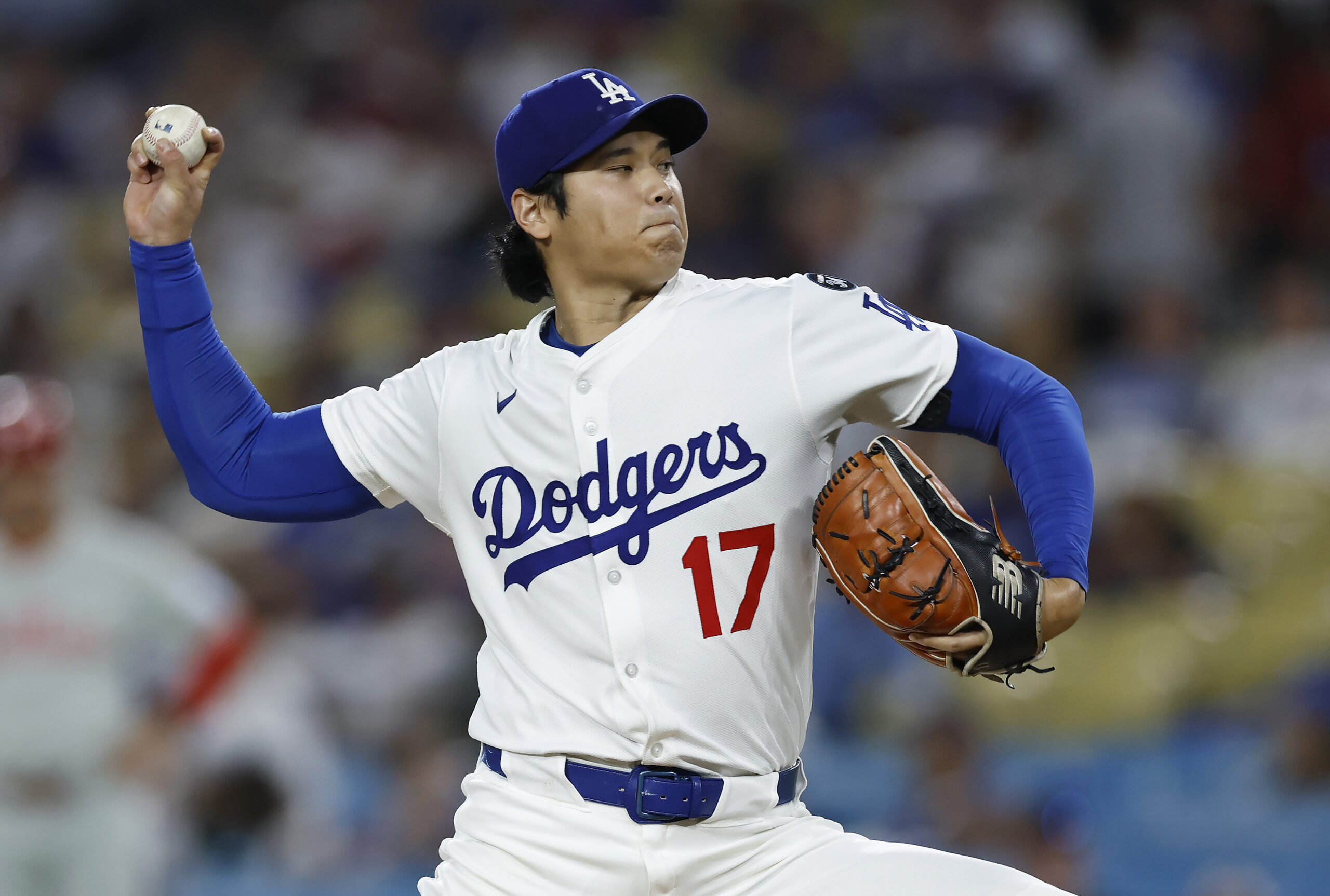 Dodgers starting pitcher Shohei Ohtani throws to the plate against...