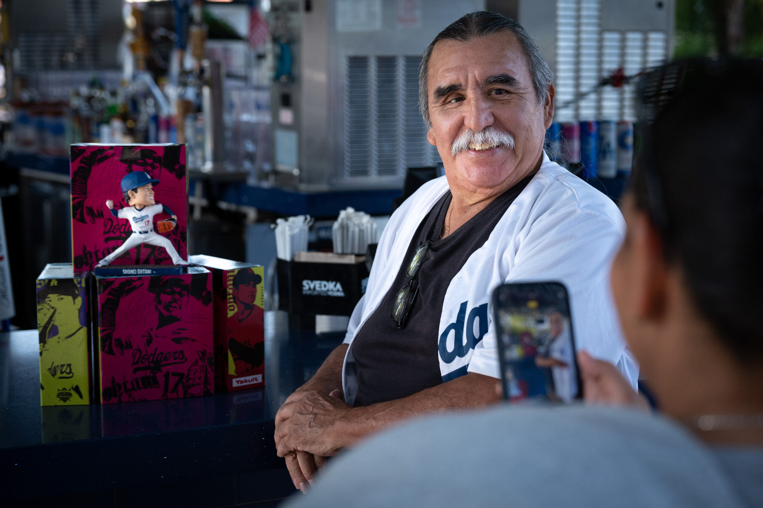 Ralph Valenzuela poses with his Shohei Ohtani promotional bobblehead before...