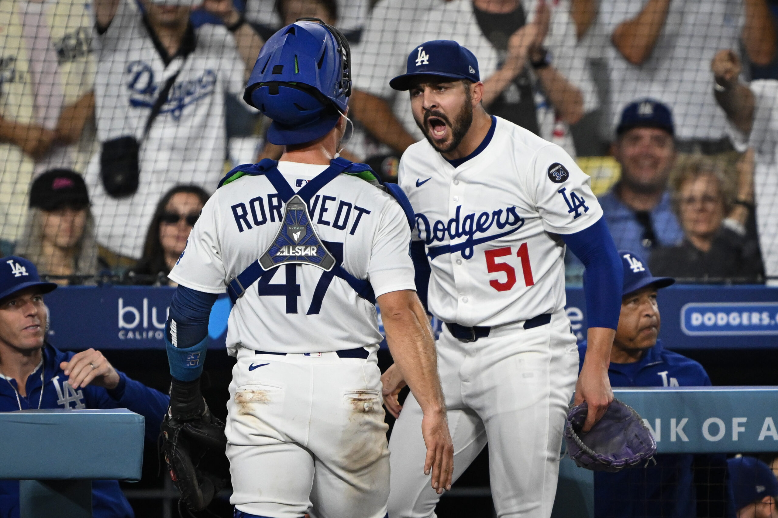 Dodgers relief pitcher Alex Vesia, right, greets catcher Ben Rortvedt...