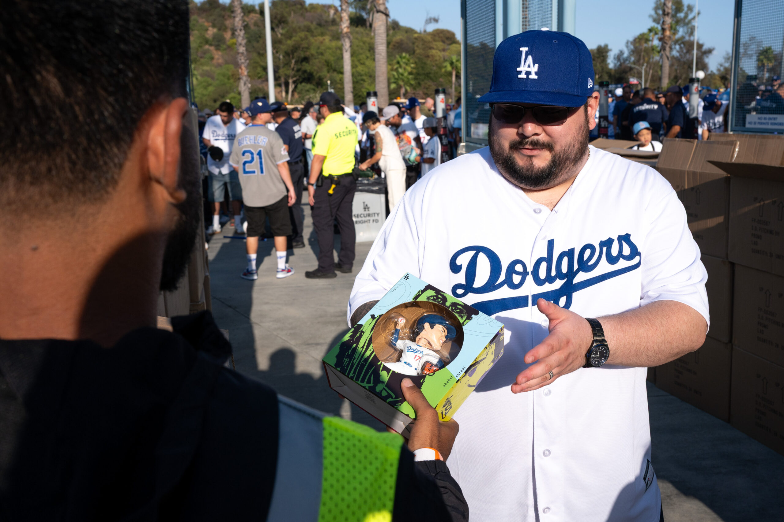 Fans receive Shohei Ohtani promotional bobbleheads before a game between...