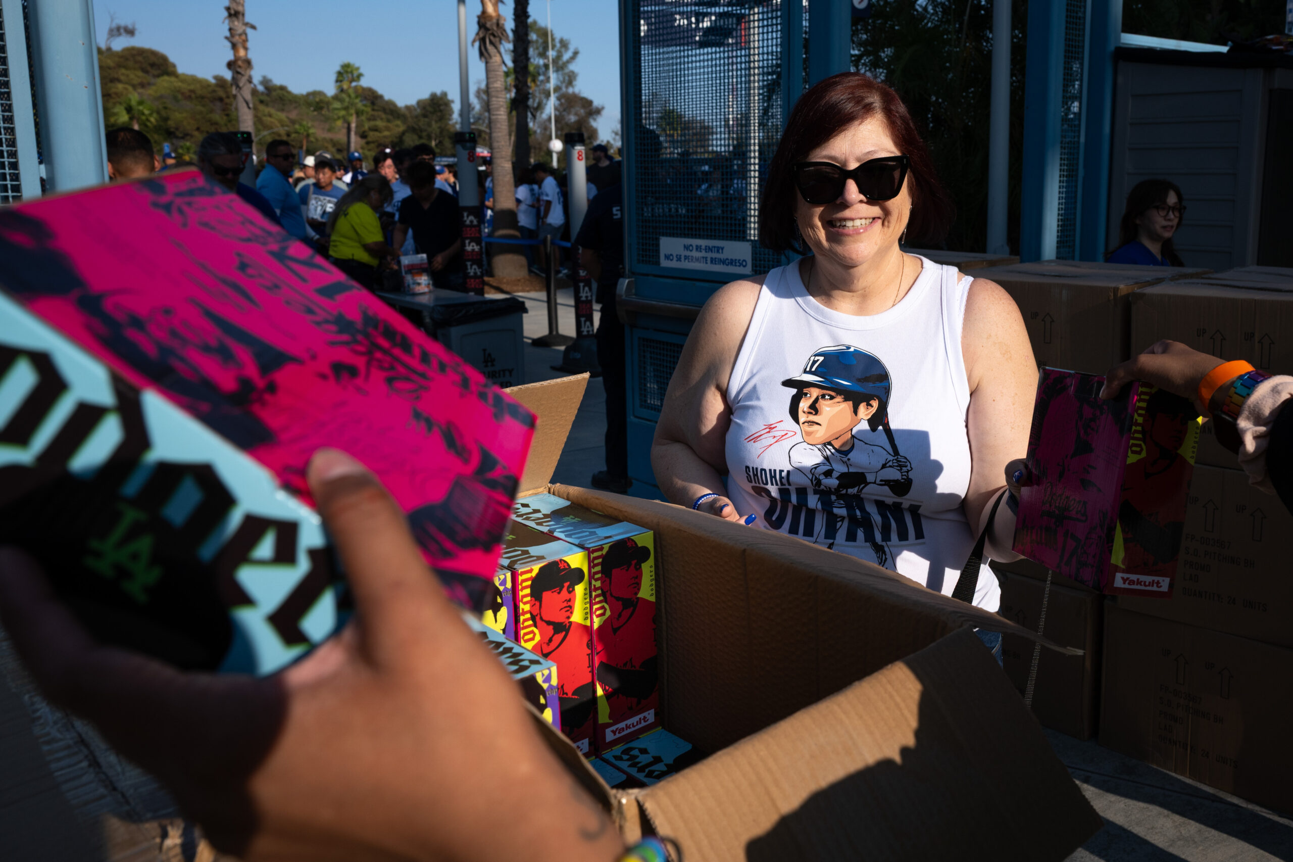 Fans receive Shohei Ohtani promotional bobbleheads before a game between...