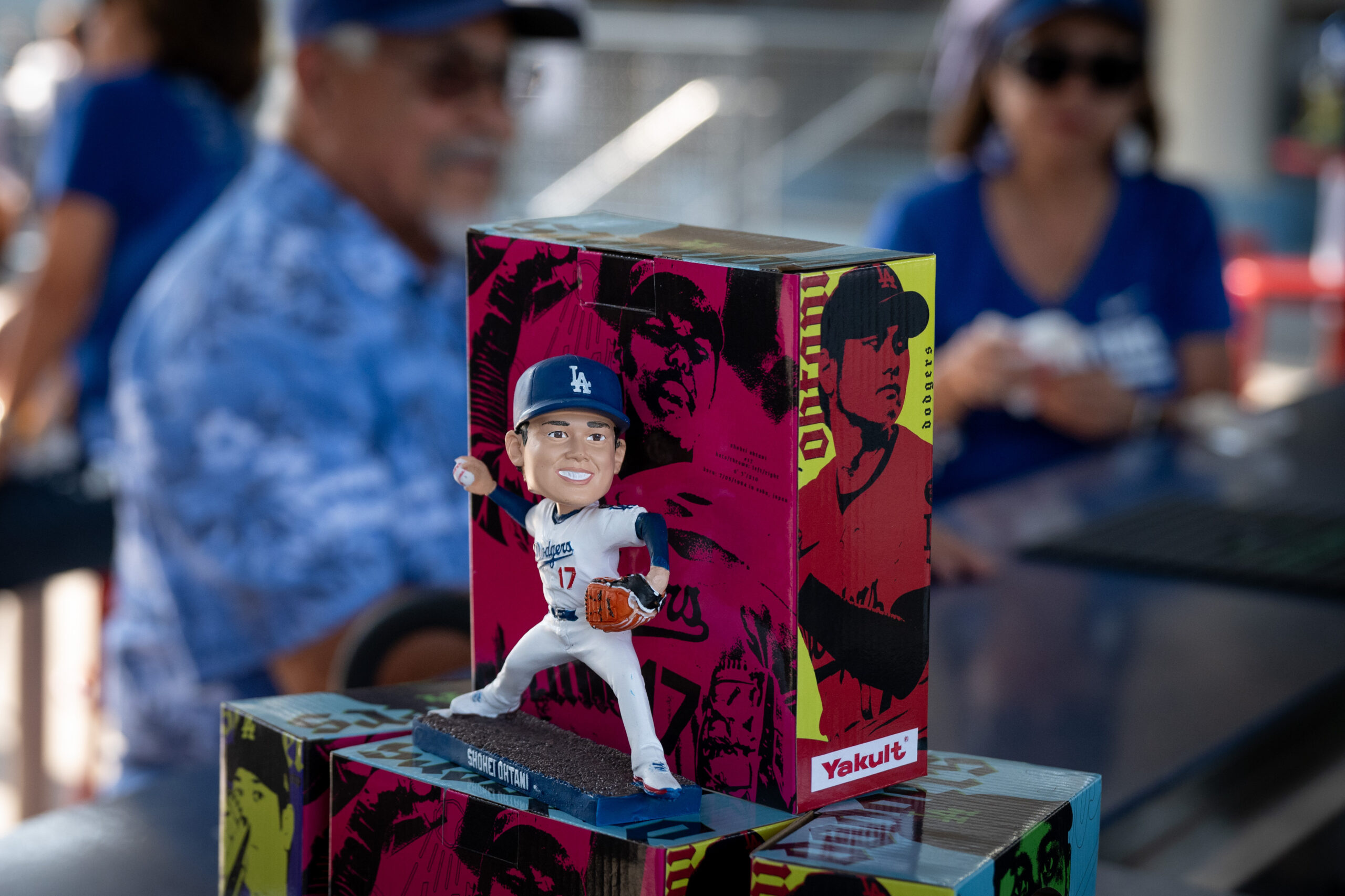 Fans receive Shohei Ohtani promotional bobbleheads before a game between...