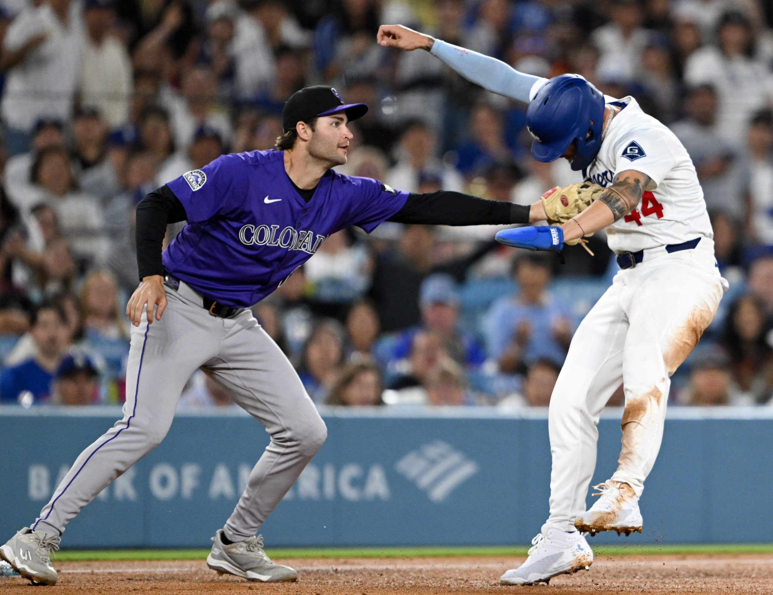 The Dodgers’ Andy Pages, right, is tagged out by Colorado...