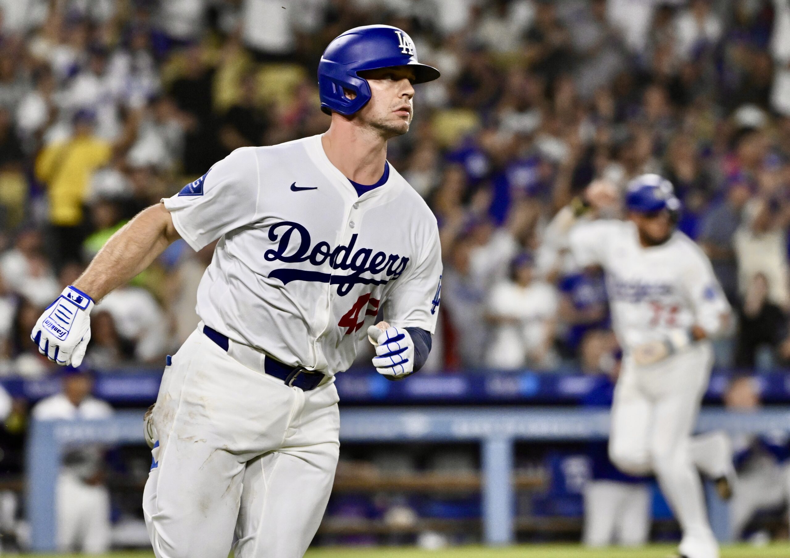 The Dodgers’ Ben Rortvedt, left, runs to first base after...