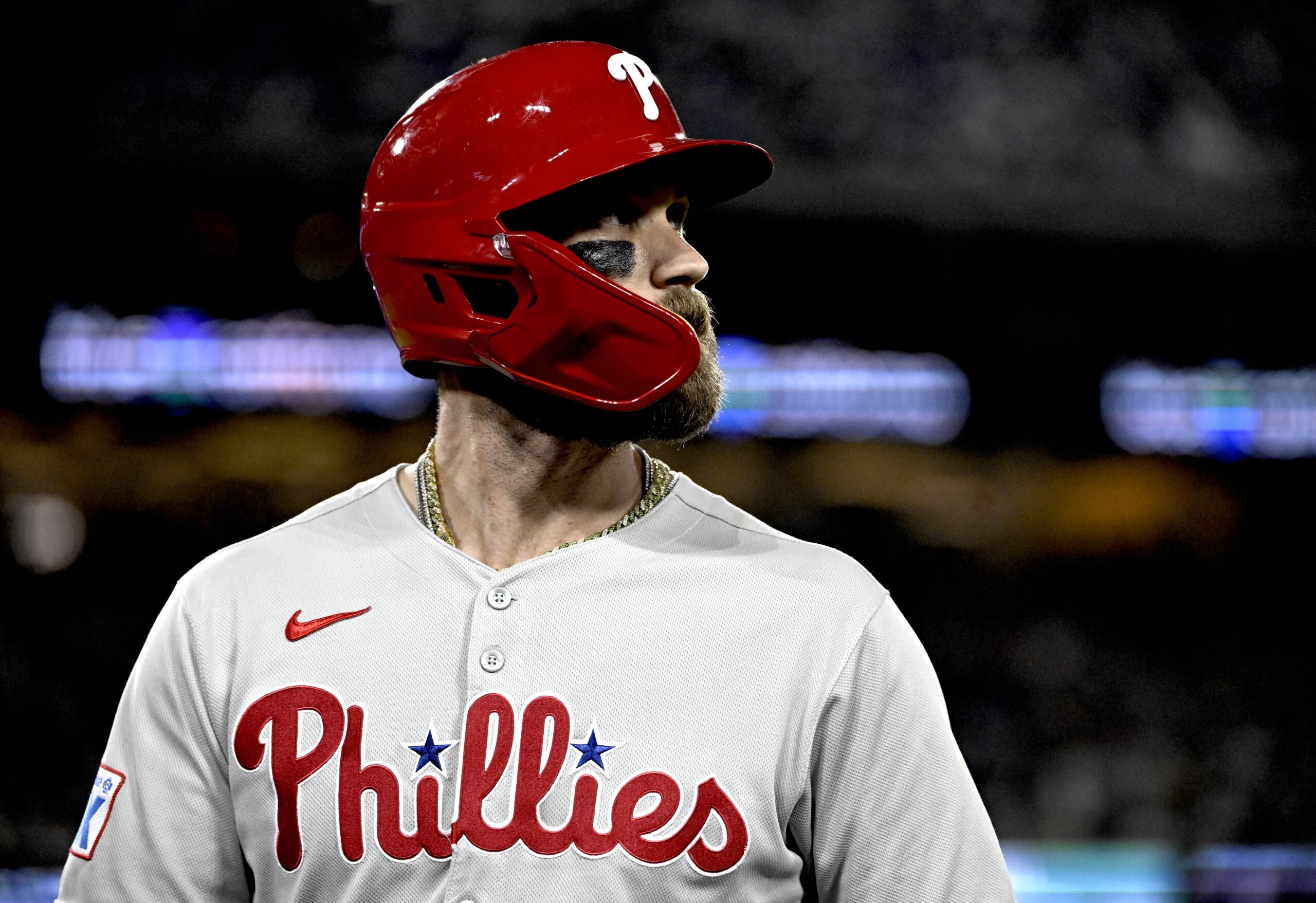 Philadelphia Phillies star Bryce Harper looks on as he walks...