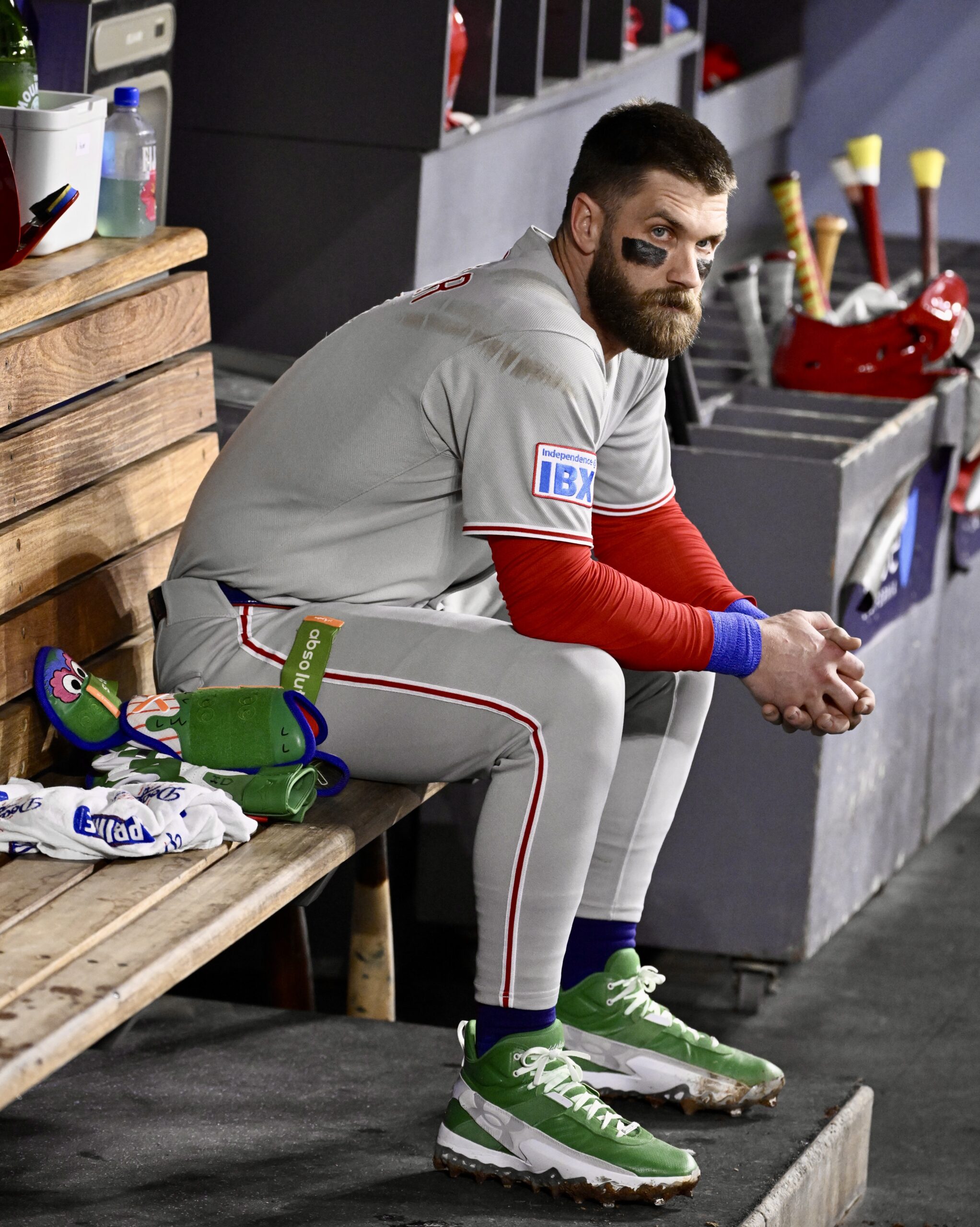 Philadelphia Phillies star Bryce Harper sits in the dugout after...