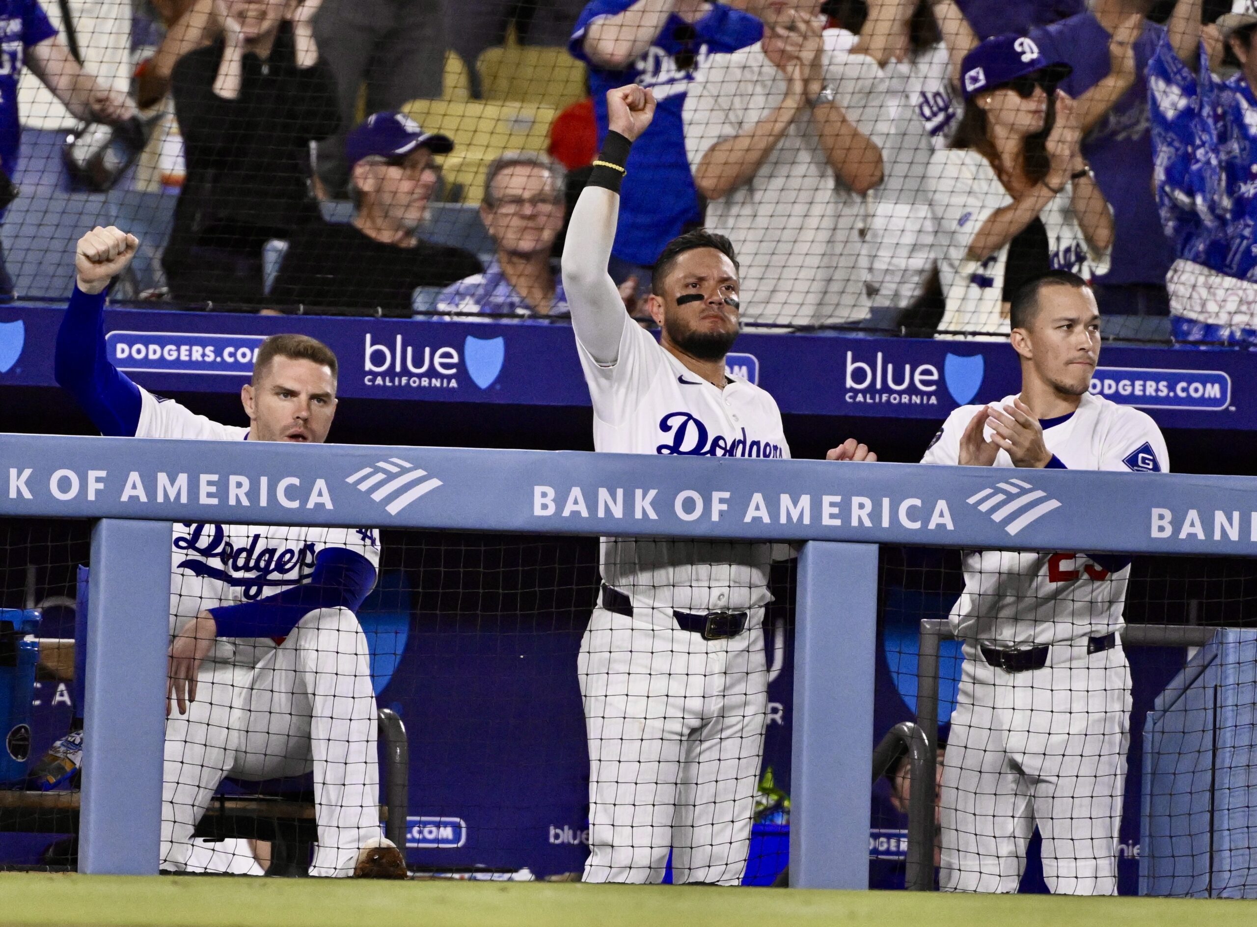 Dodgers players Freddie Freeman, left, Miguel Rojas, center, and Tommy...