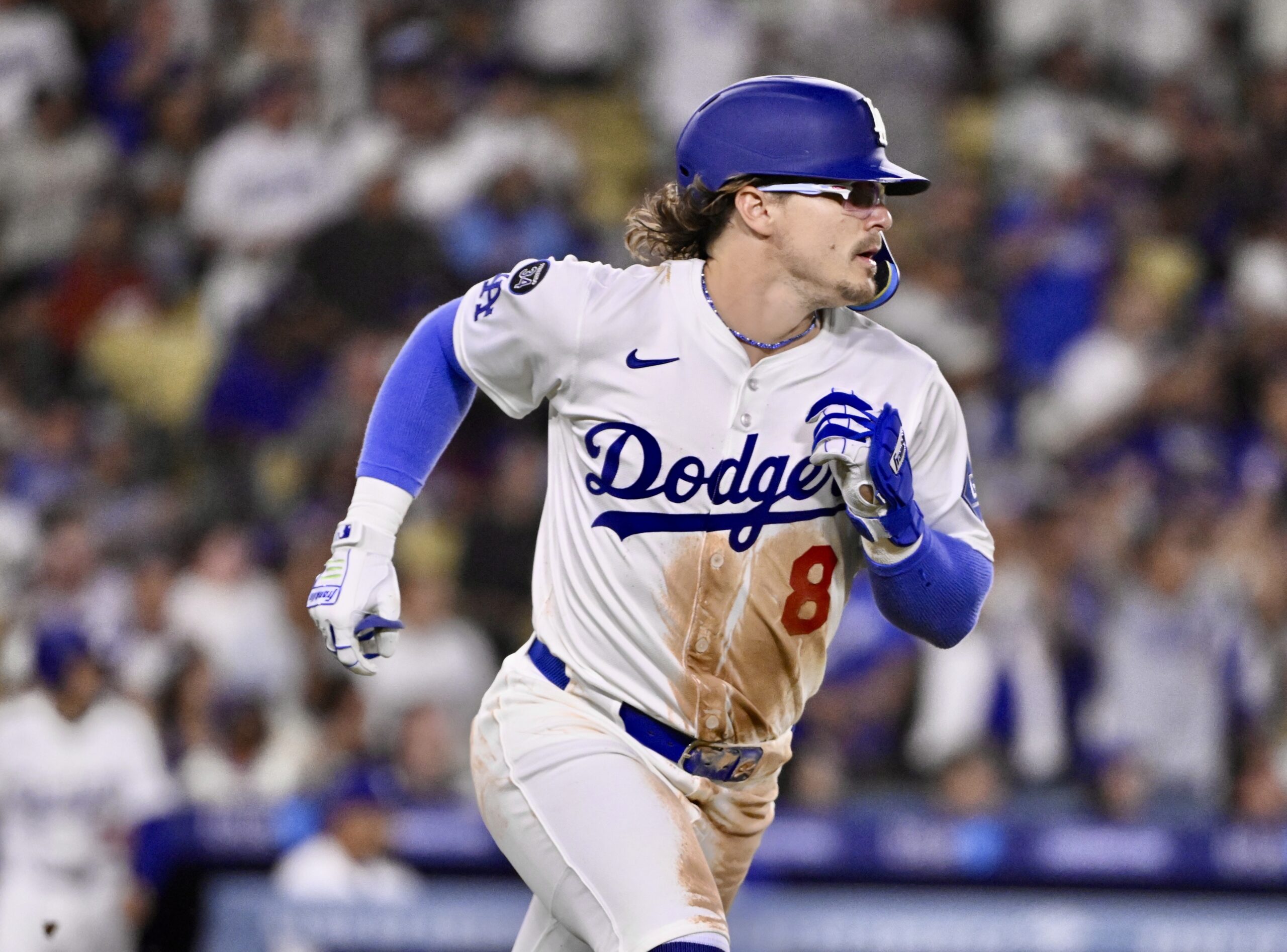 The Dodgers’ Kike Hernandez runs to first base after hitting...