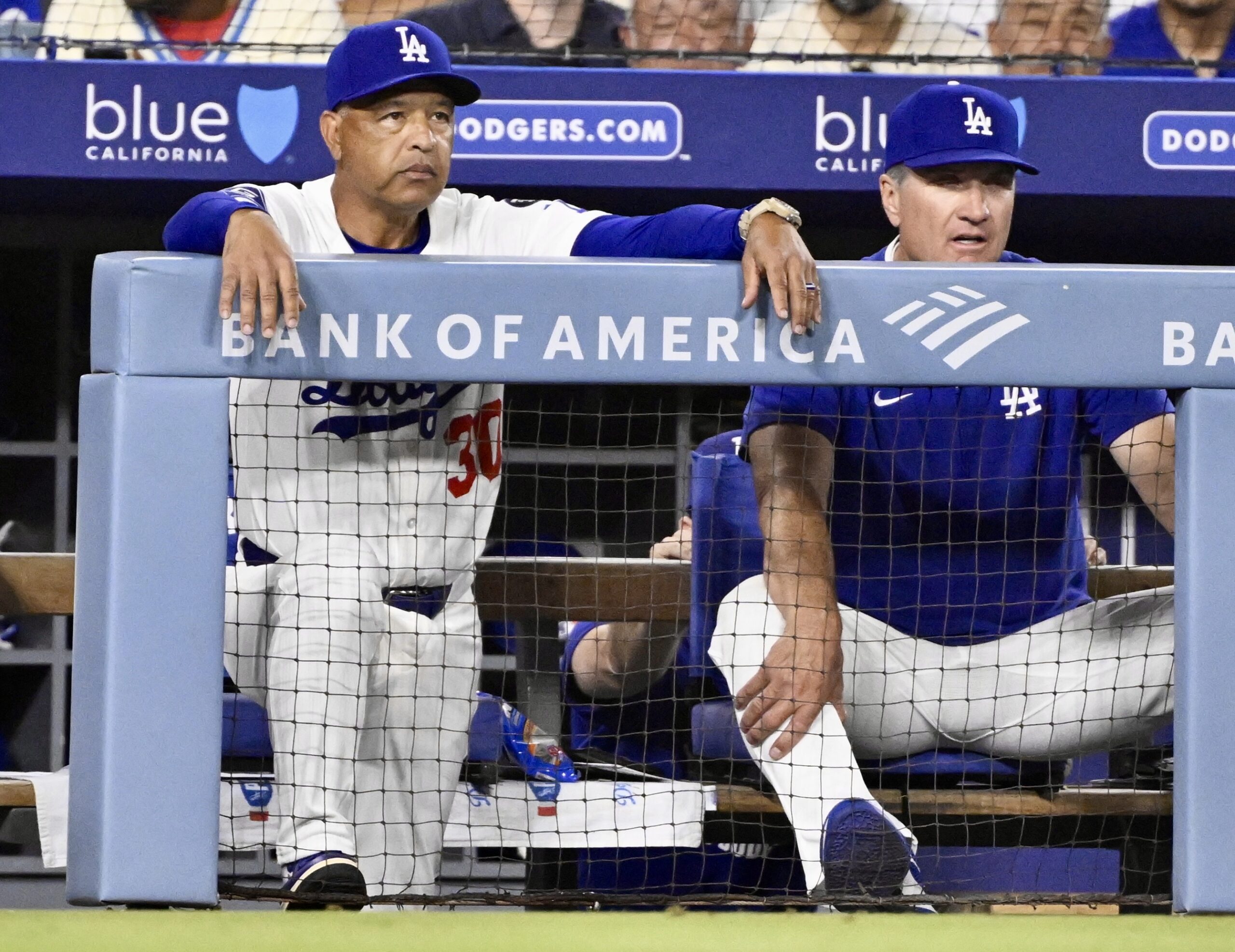 Dodgers manager Dave Roberts, left, and coach Bob Geren look...
