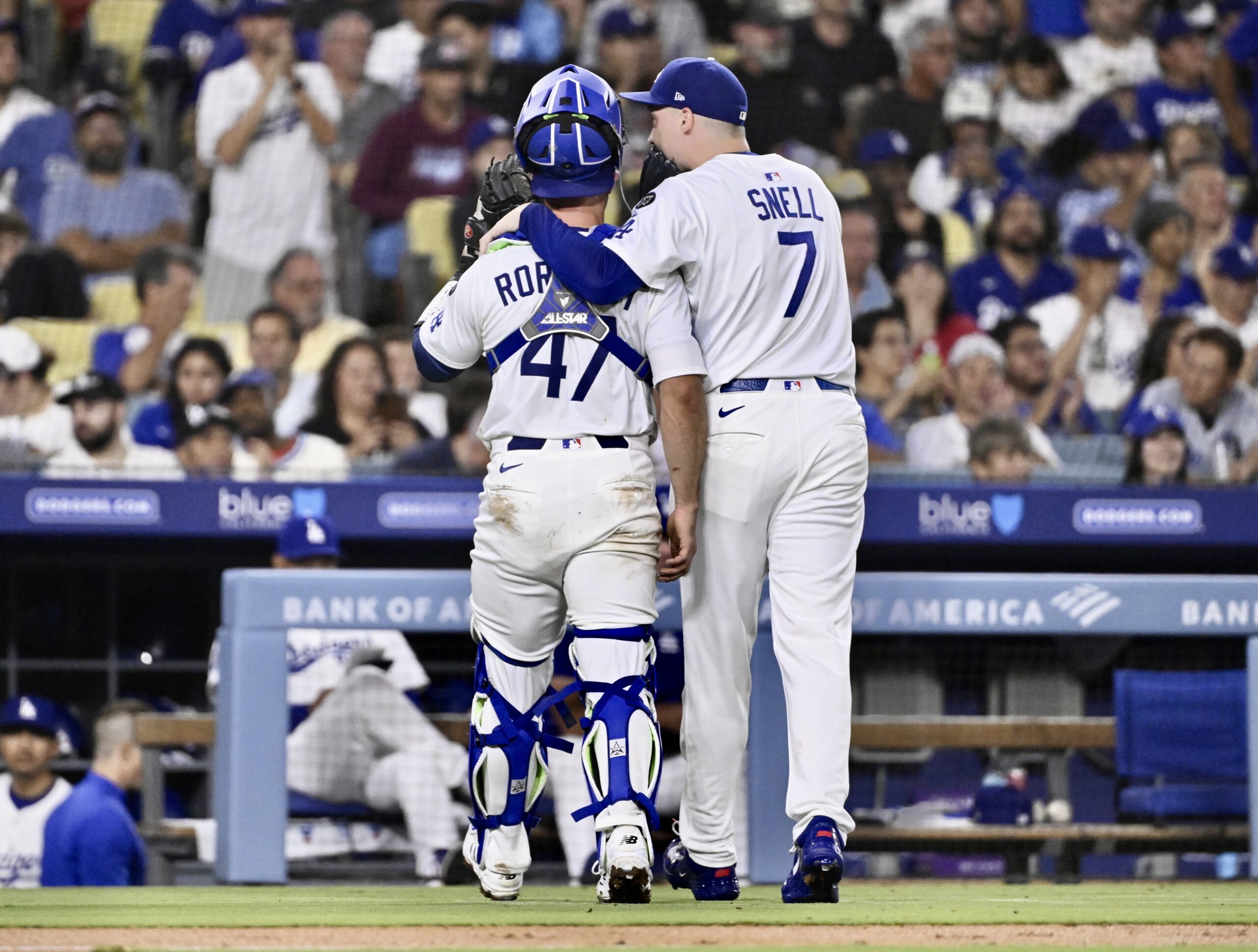 Dodgers starting pitcher Blake Snell, right, speaks to catcher Ben...