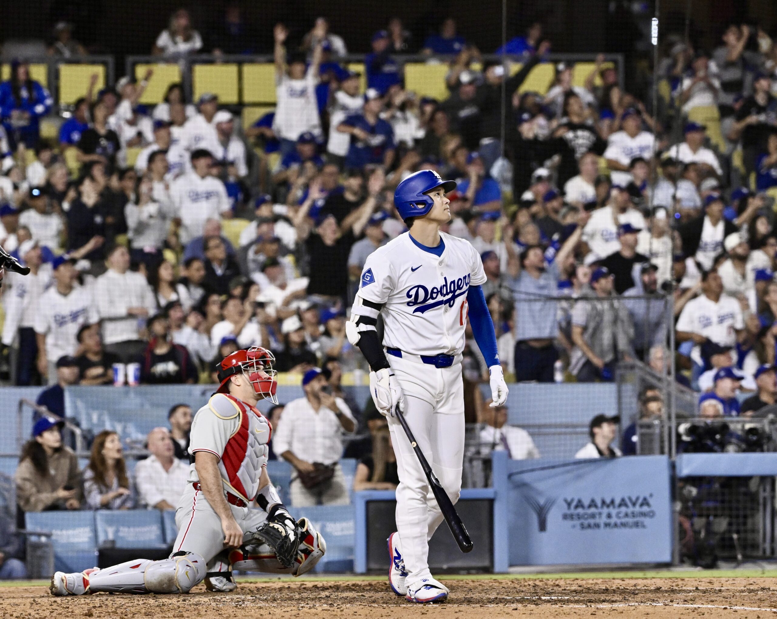 Dodgers star Shohei Ohtani watches the flight of his solo...