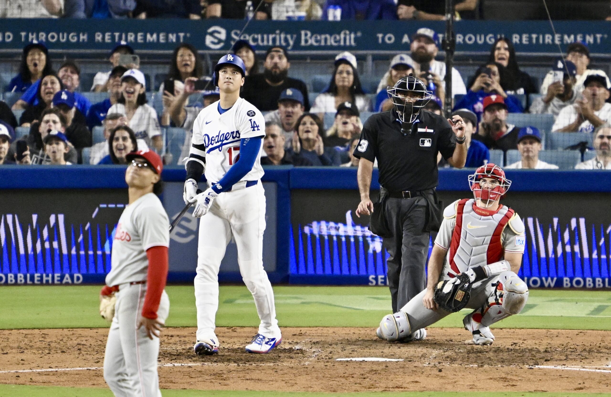 Dodgers star Shohei Ohtani watches the flight of his solo...