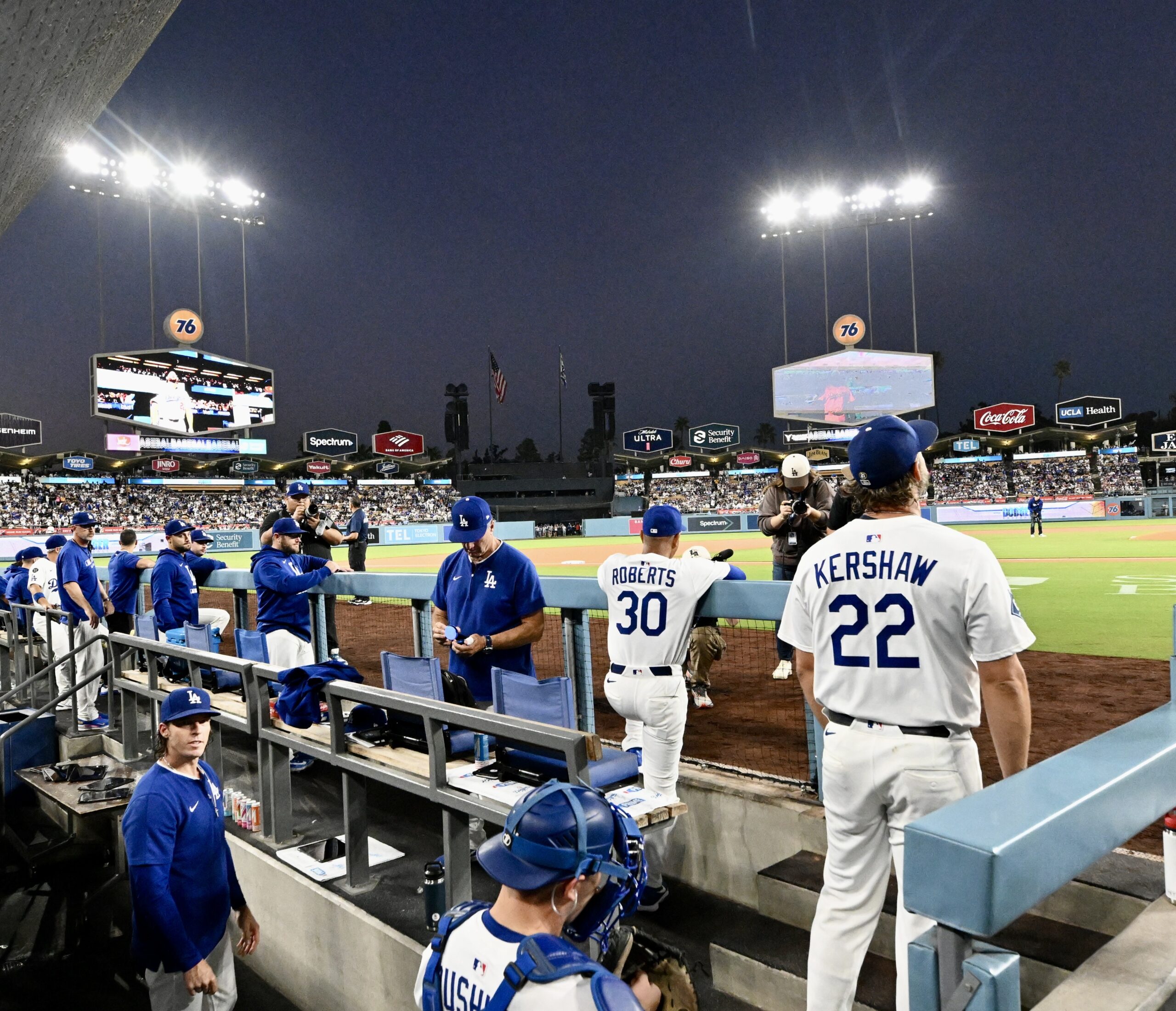 Dodgers starting pitcher Clayton Kershaw stands in the dugout before...