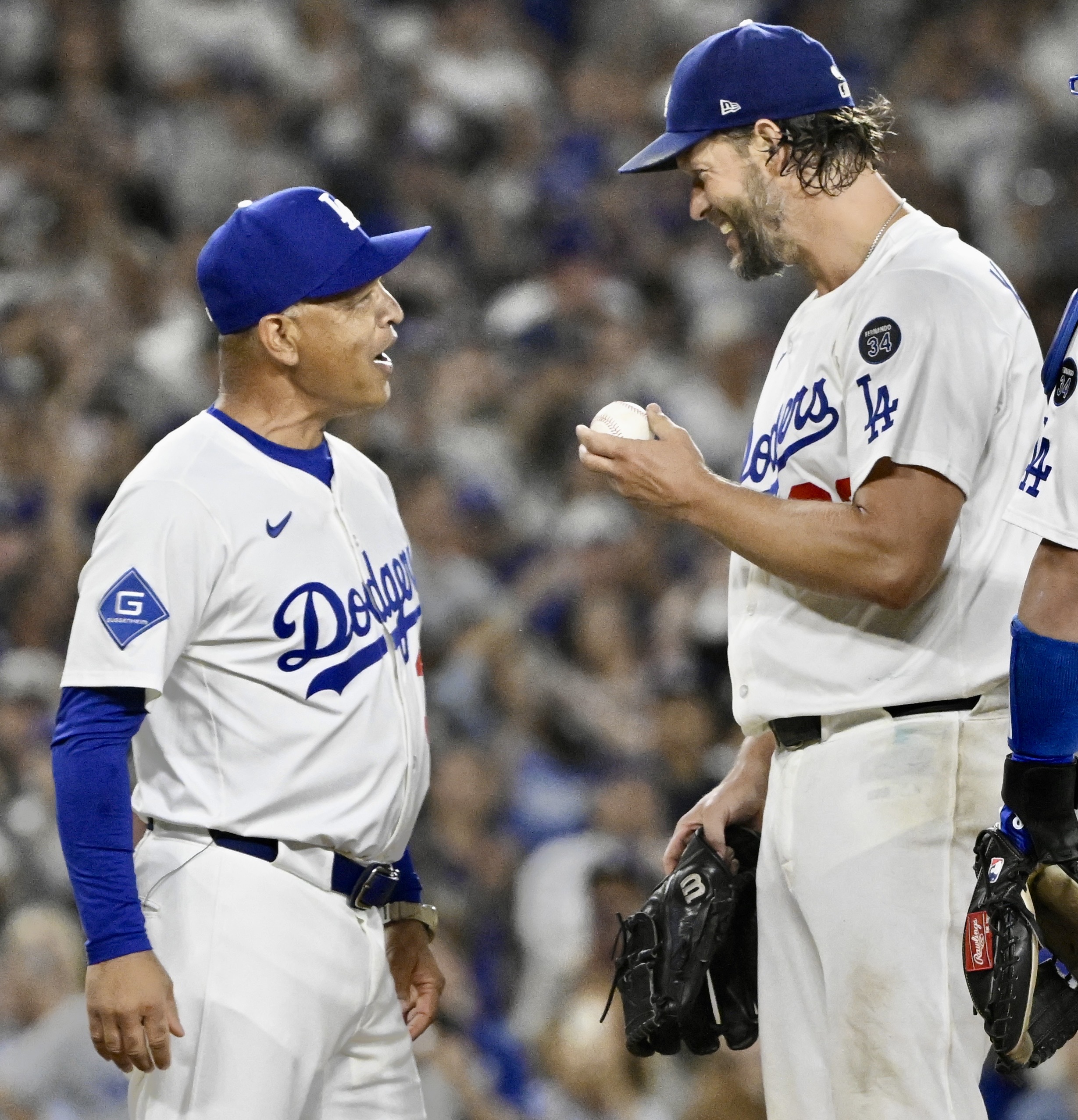 Dodgers starting pitcher Clayton Kershaw shows the game ball to...