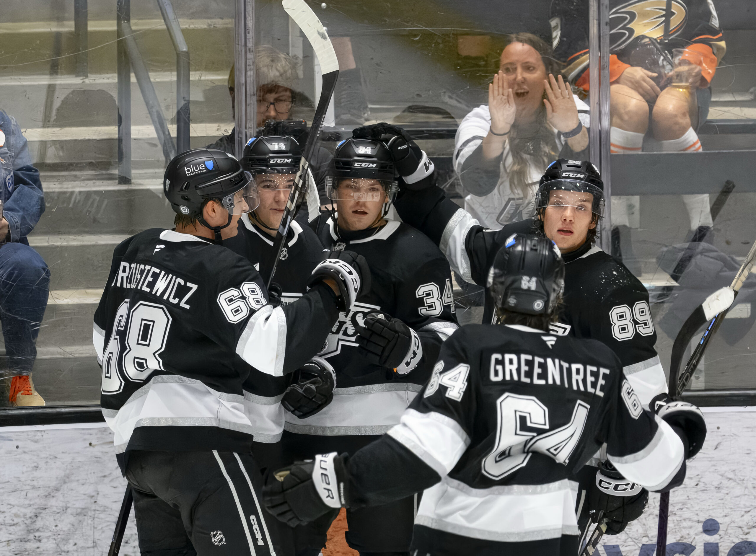 The Kings’ Kenny Connors, center, is congratulated by teammates after...
