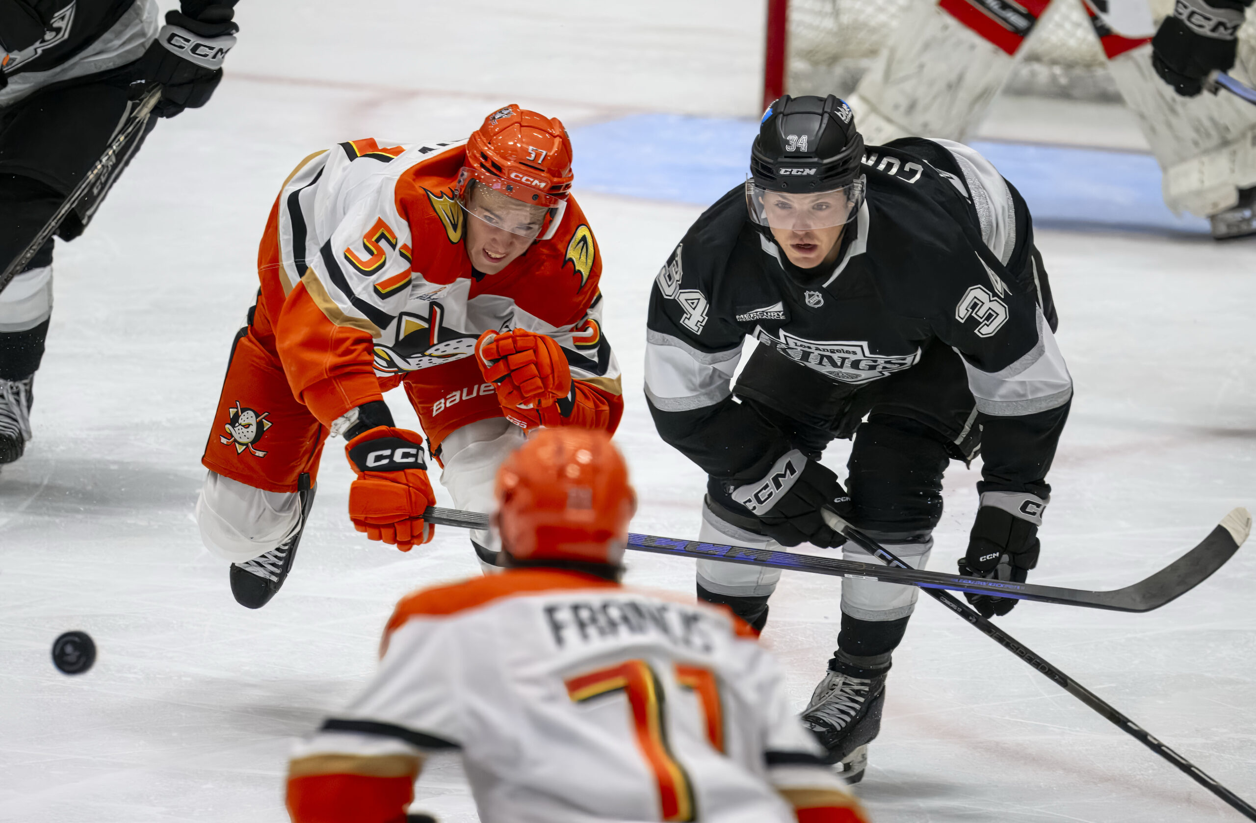 The Ducks’ Yegor Sidorov, left, hits the puck toward a...