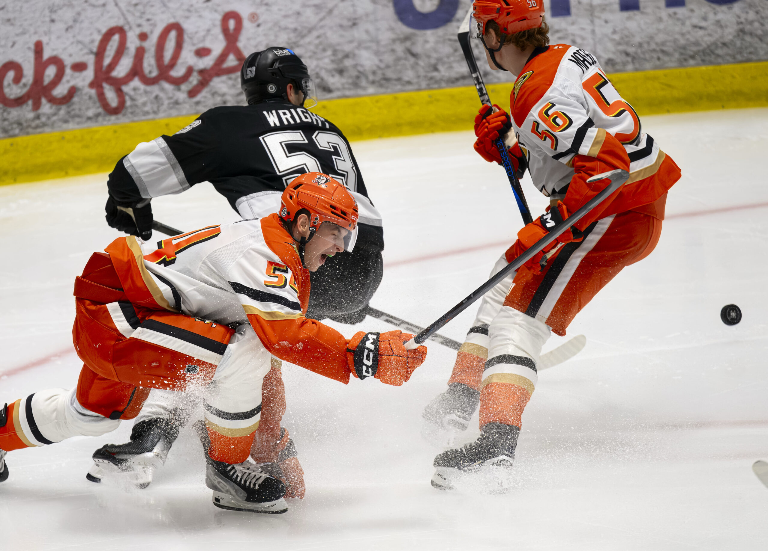 The Ducks’ Tarin Smith slaps the puck away from the...