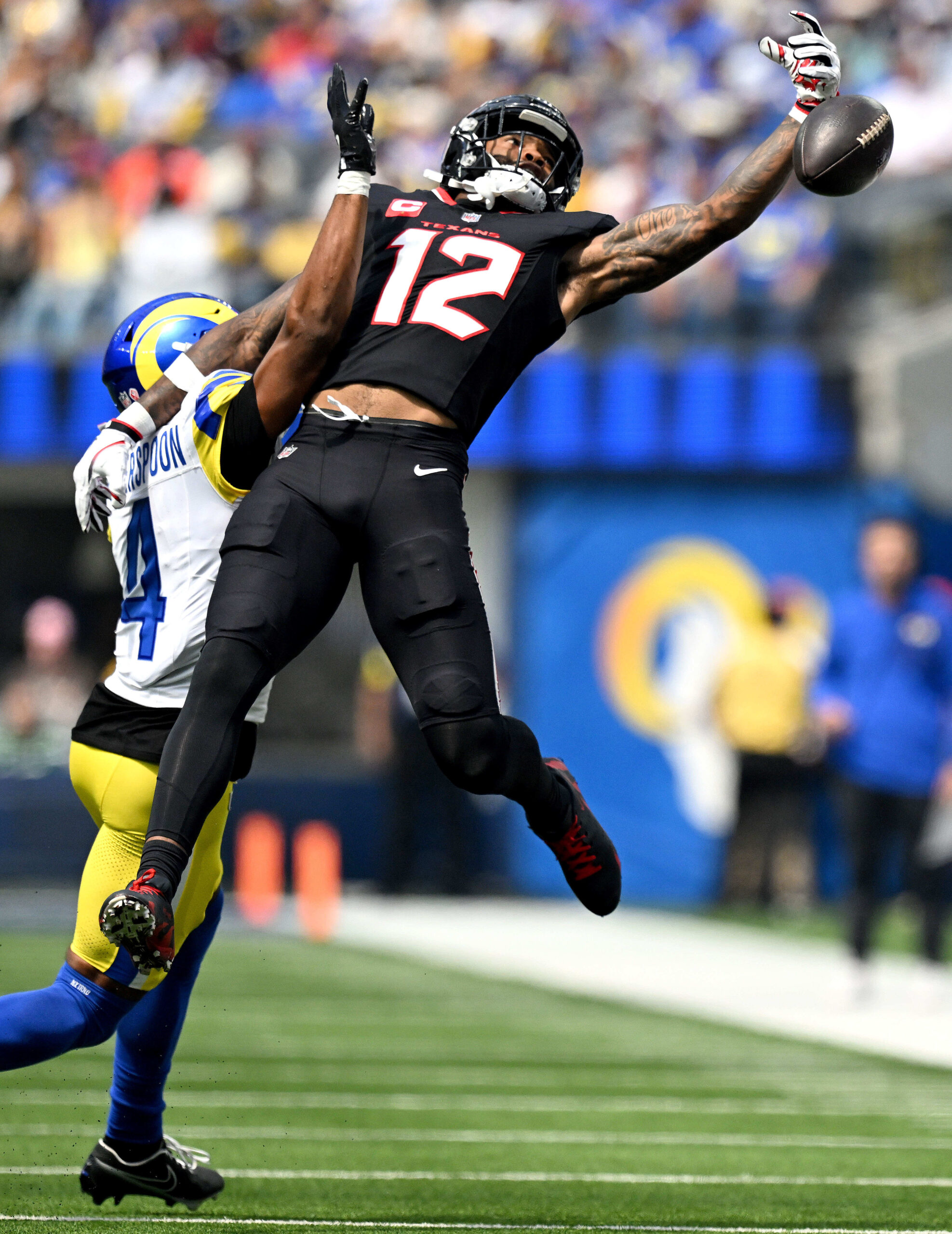 The Rams Ahkello Witherspoon, left, defends Houston wide receiver Nico...
