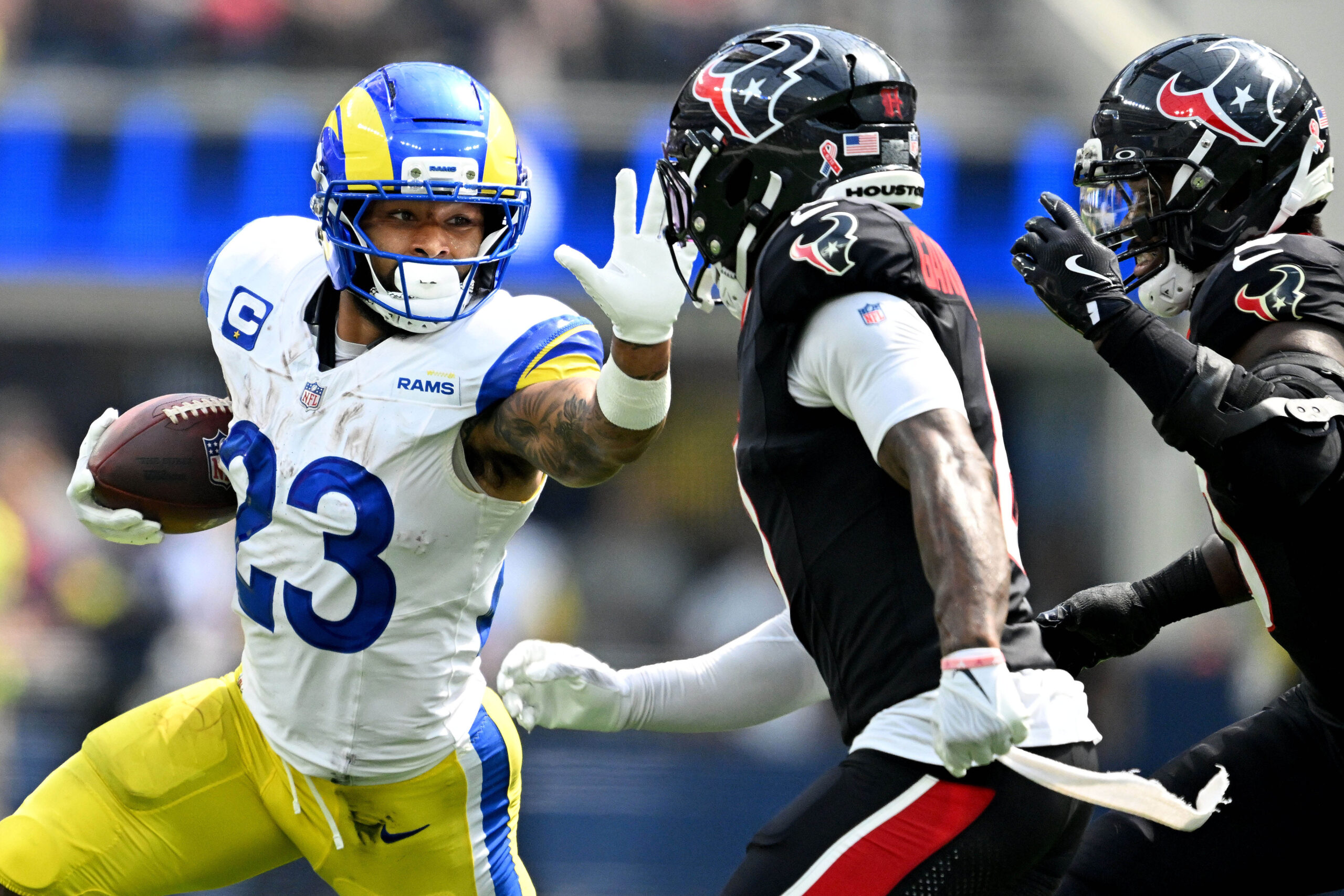 Rams running back Kyren Williams stiff arms Houston’s C.J. Gardner-Johnson...