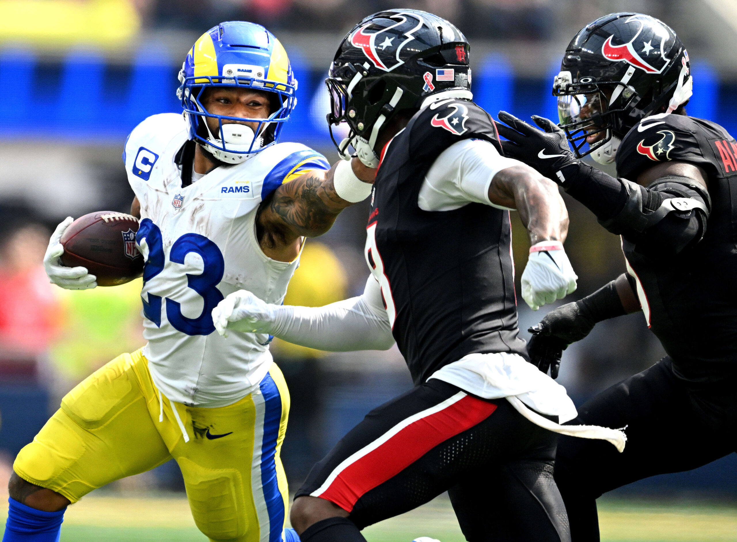 Rams running back Kyren Williams stiff arms Houston’s C.J. Gardner-Johnson...