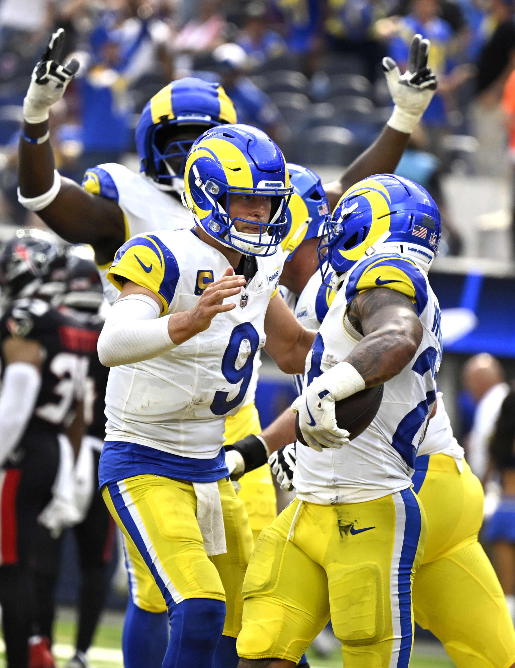 The Rams Kyren Williams, right, celebrates with quarterback Matthew Stafford...