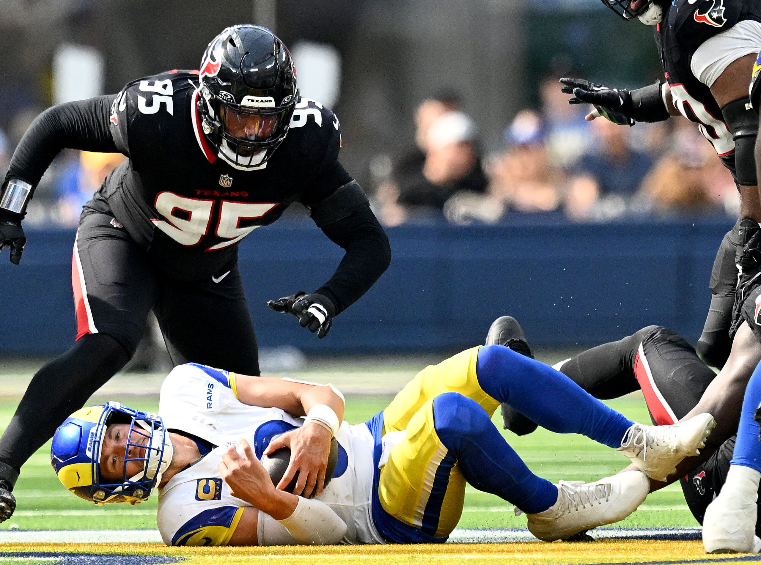 Rams quarterback Matthew Stafford is sacked by the Texans Derek...