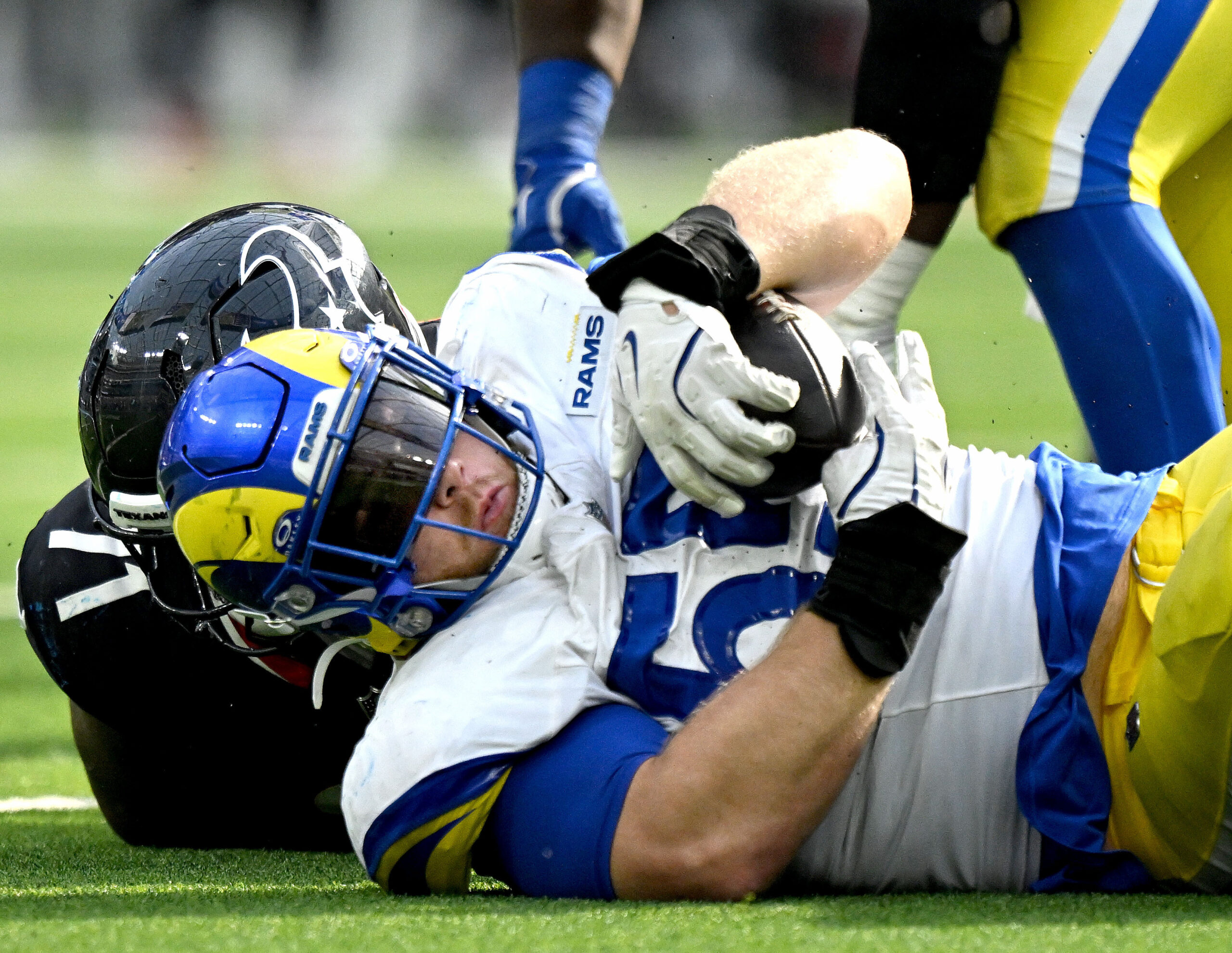 Rams defensive end Braden Fiske recovers a late Texans fumble...