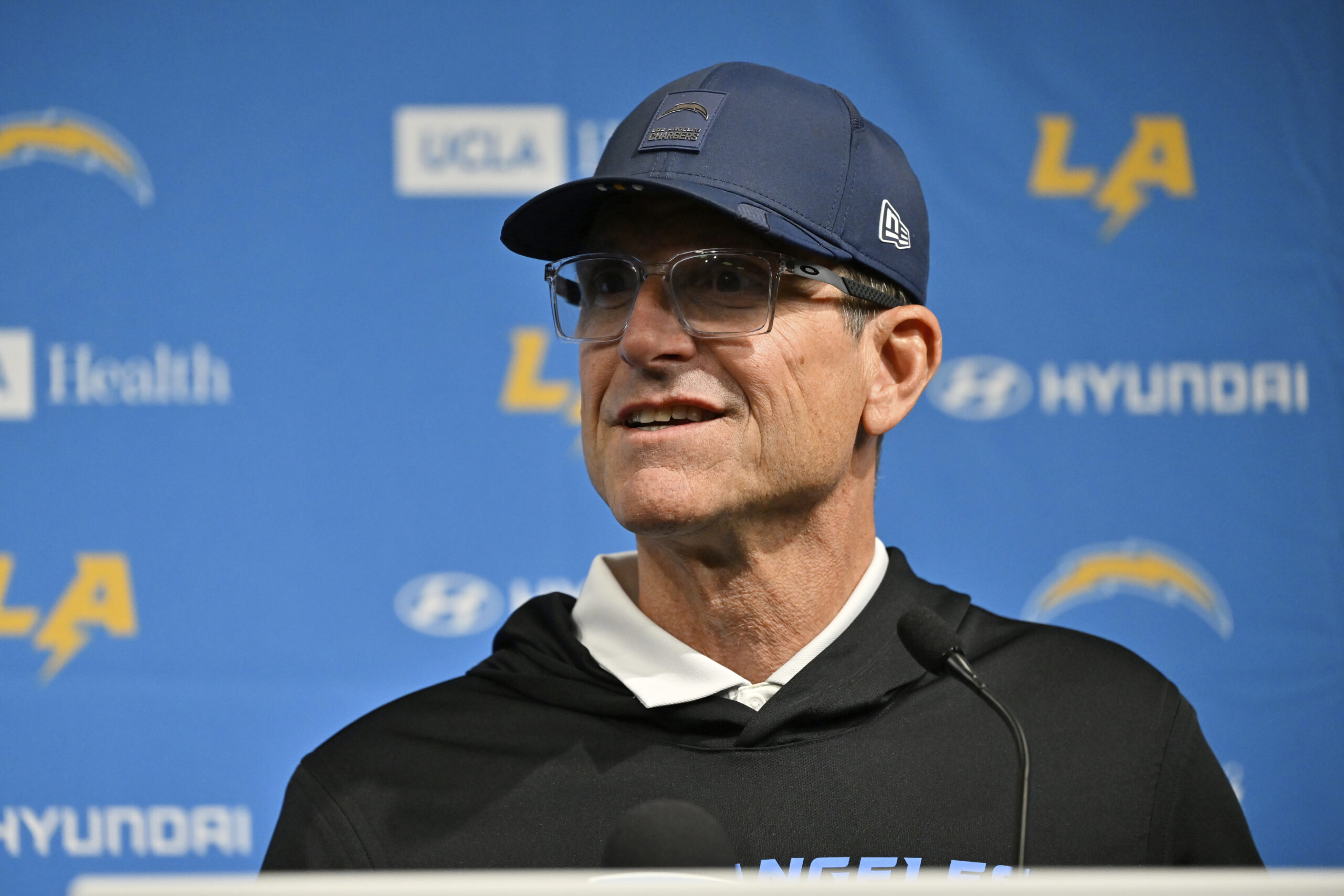 Chargers head coach Jim Harbaugh speaks during a news conference...