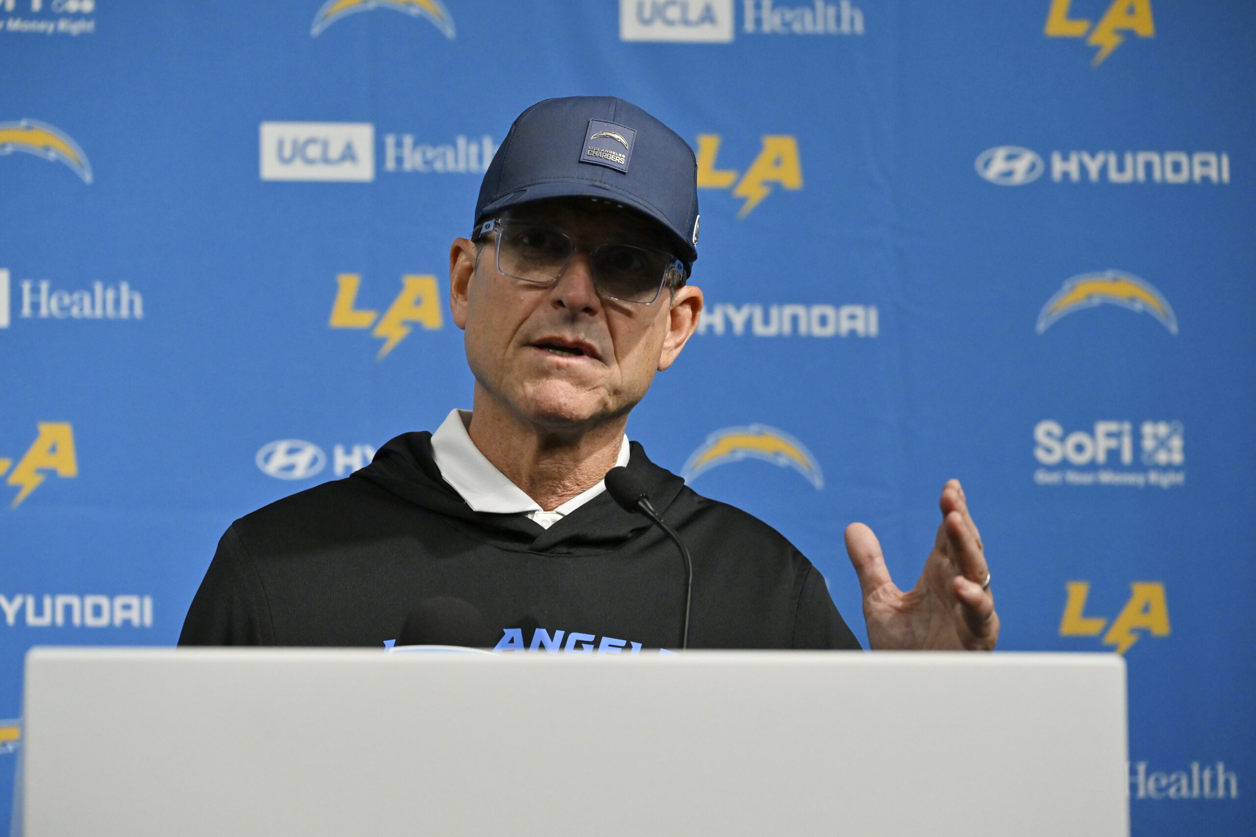 Chargers head coach Jim Harbaugh speaks during a news conference...