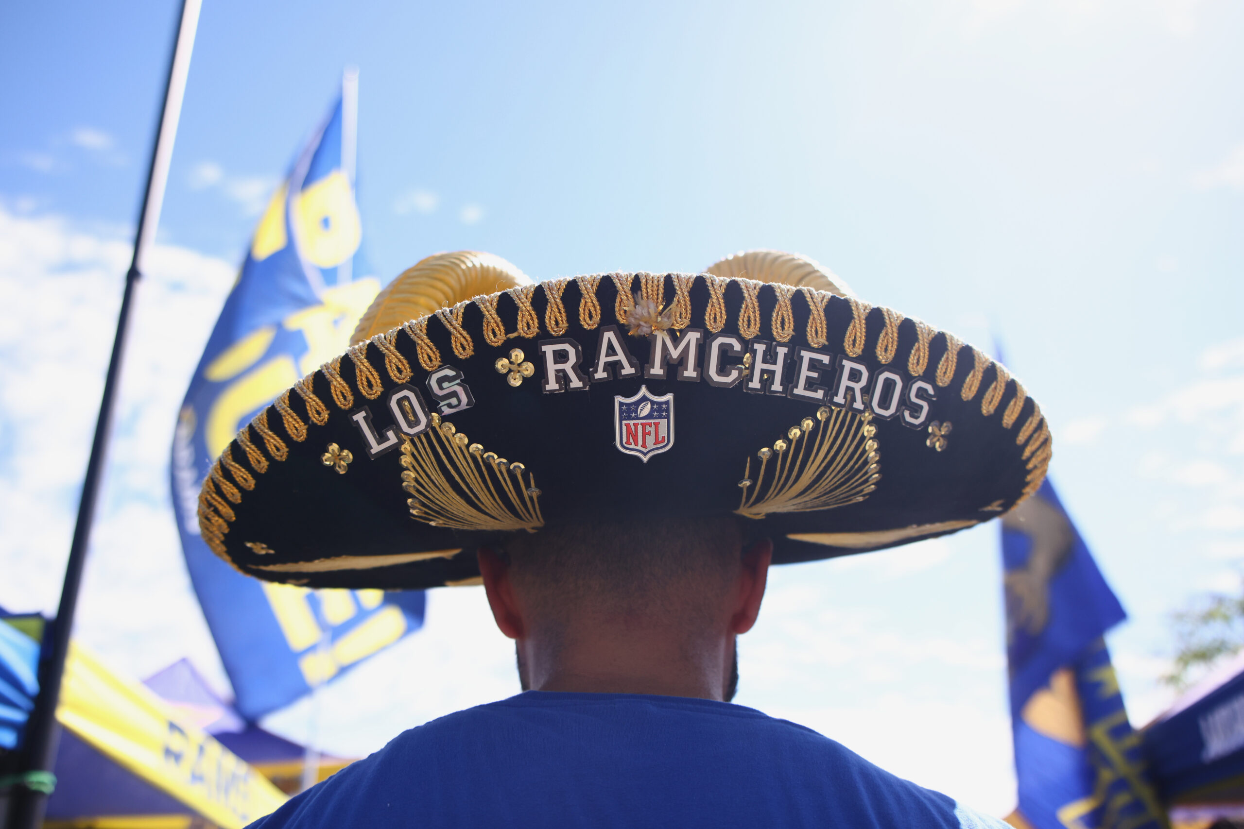 Fans tailgate before a game between the Rams and the...