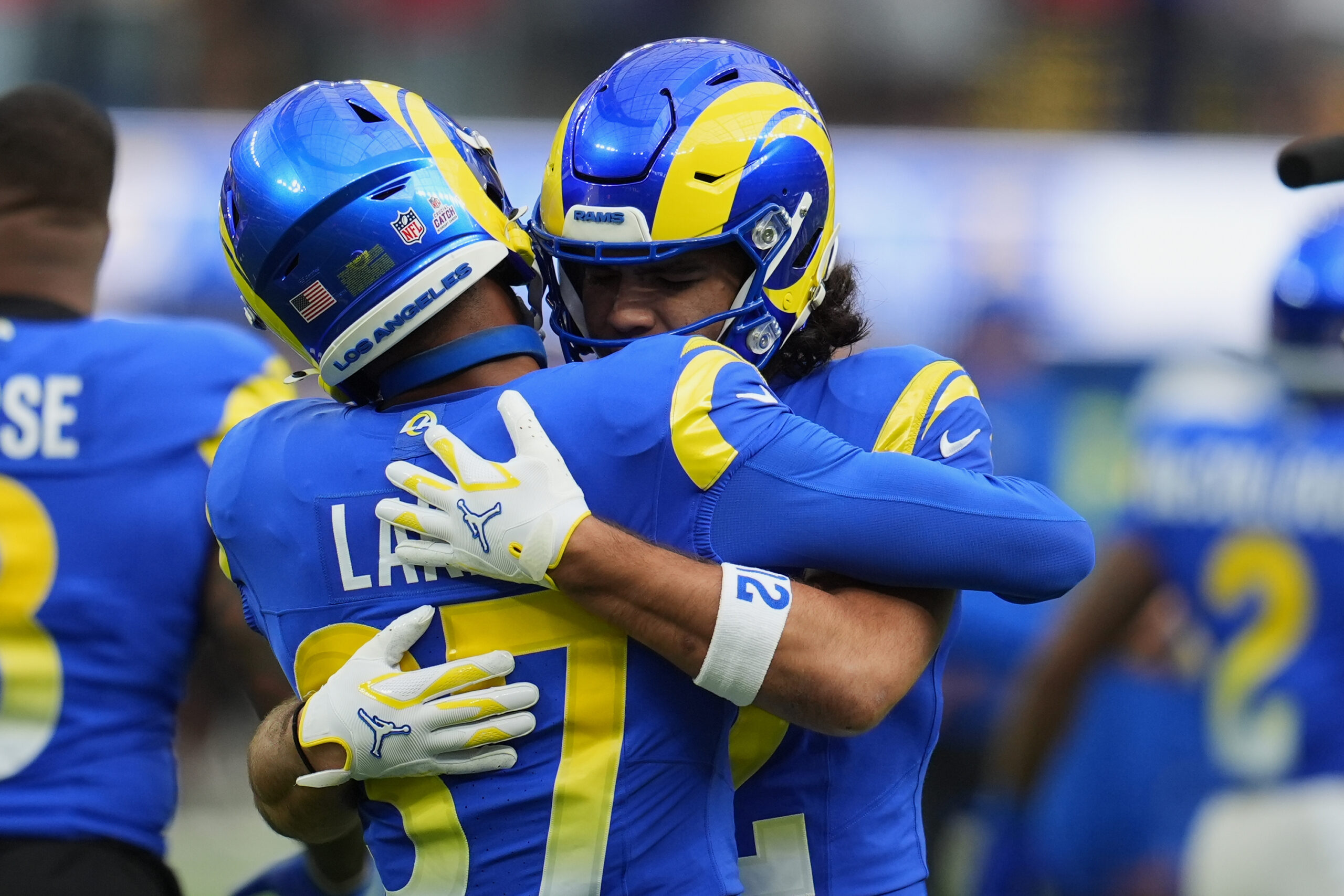 Rams safety Quentin Lake, left, hugs wide receiver Puka Nacua...