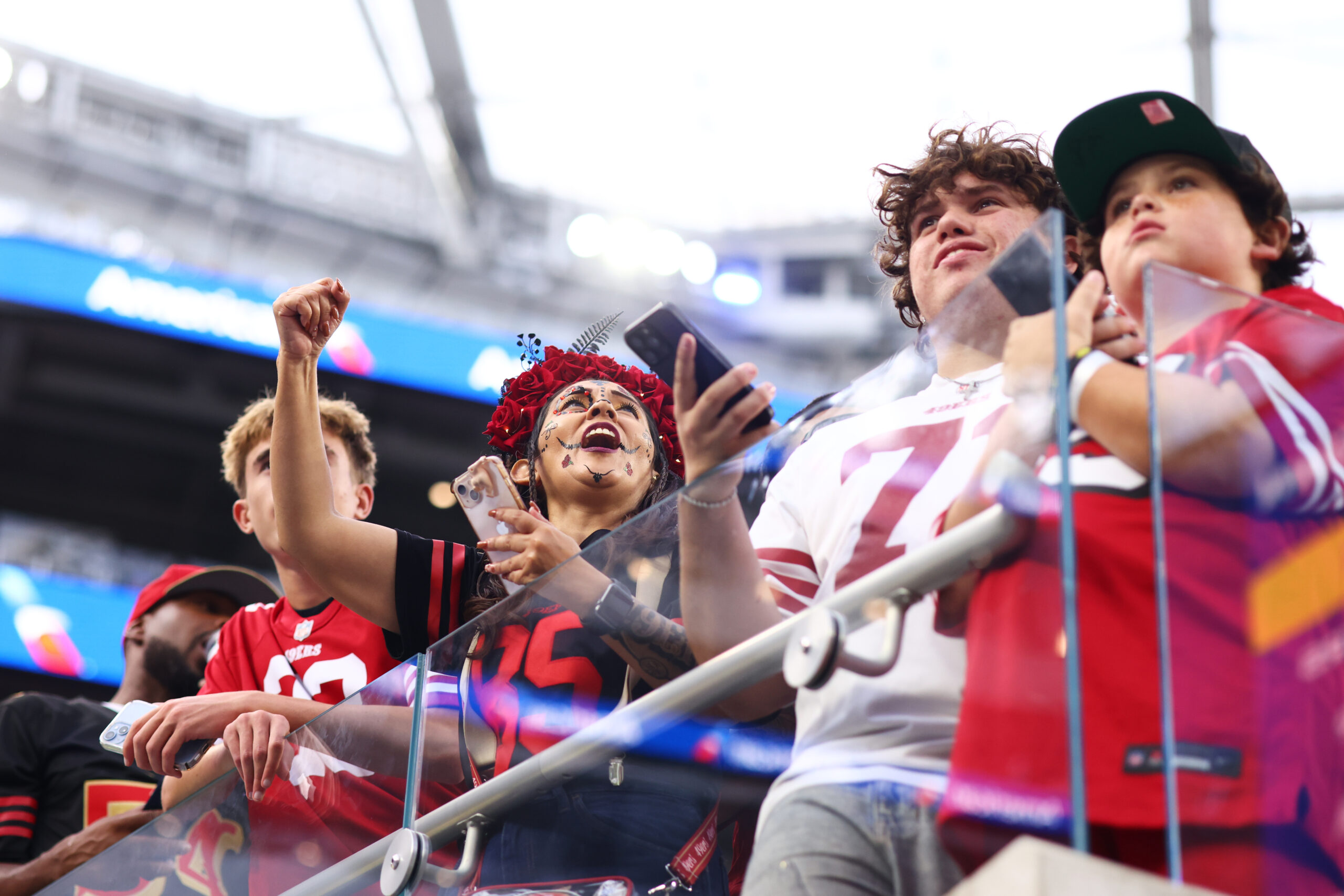 Fans cheer before an NFL football game between the Rams...