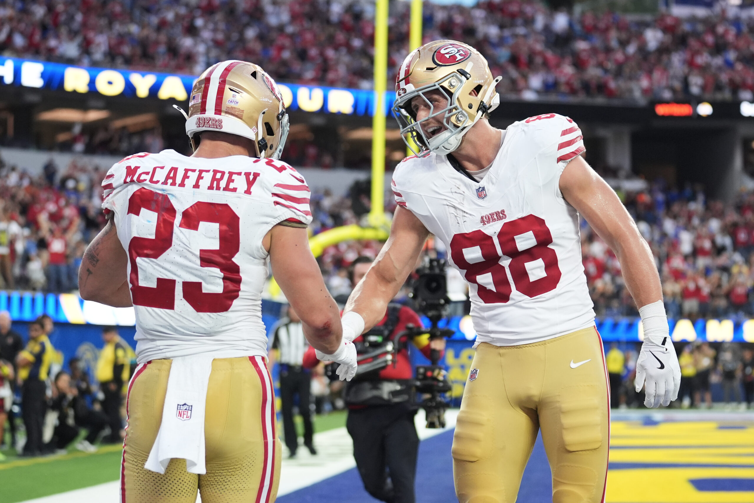 San Francisco 49ers running back Christian McCaffrey (23) is congratulated...