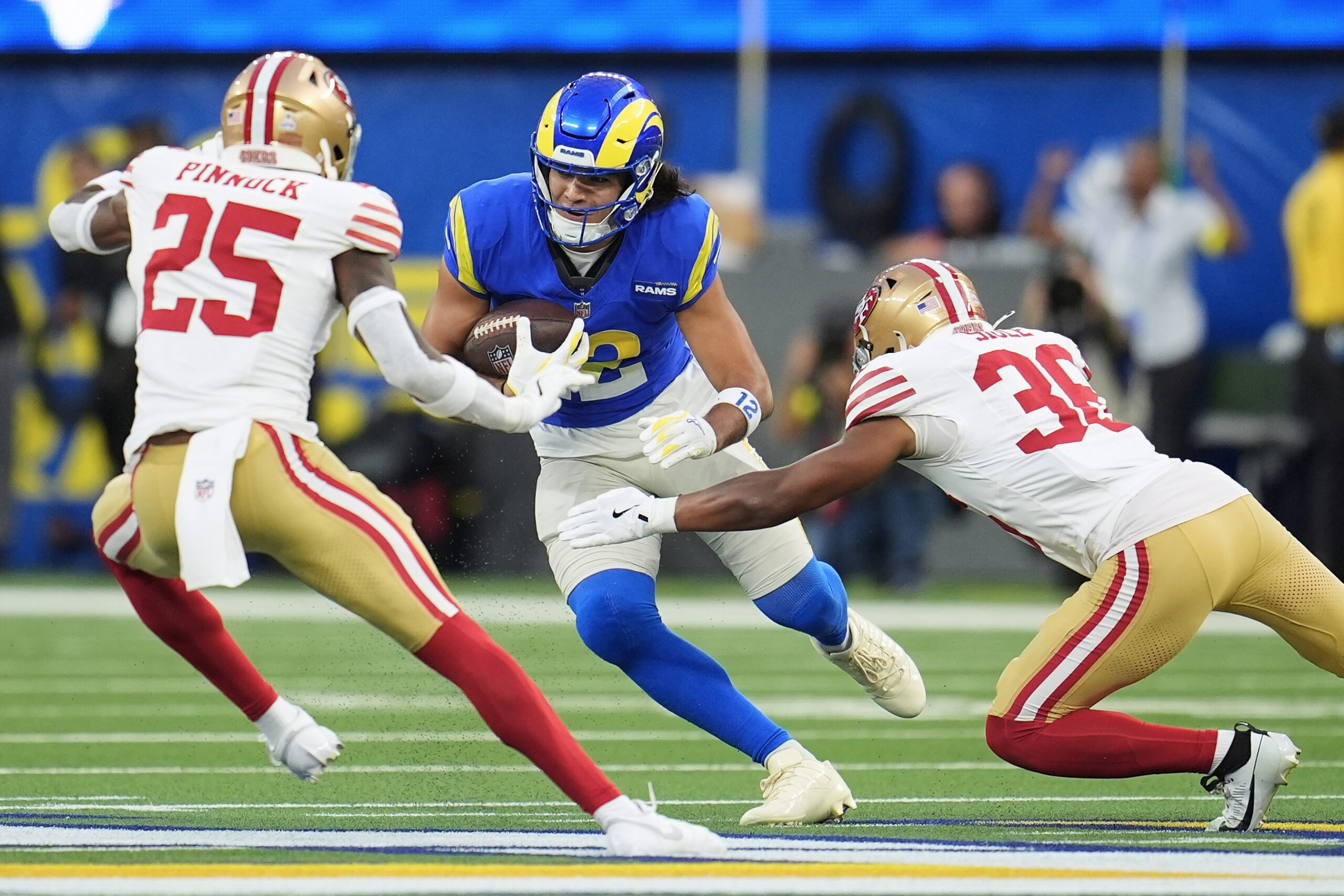 Rams wide receiver Puka Nacua, middle, runs against San Francisco...