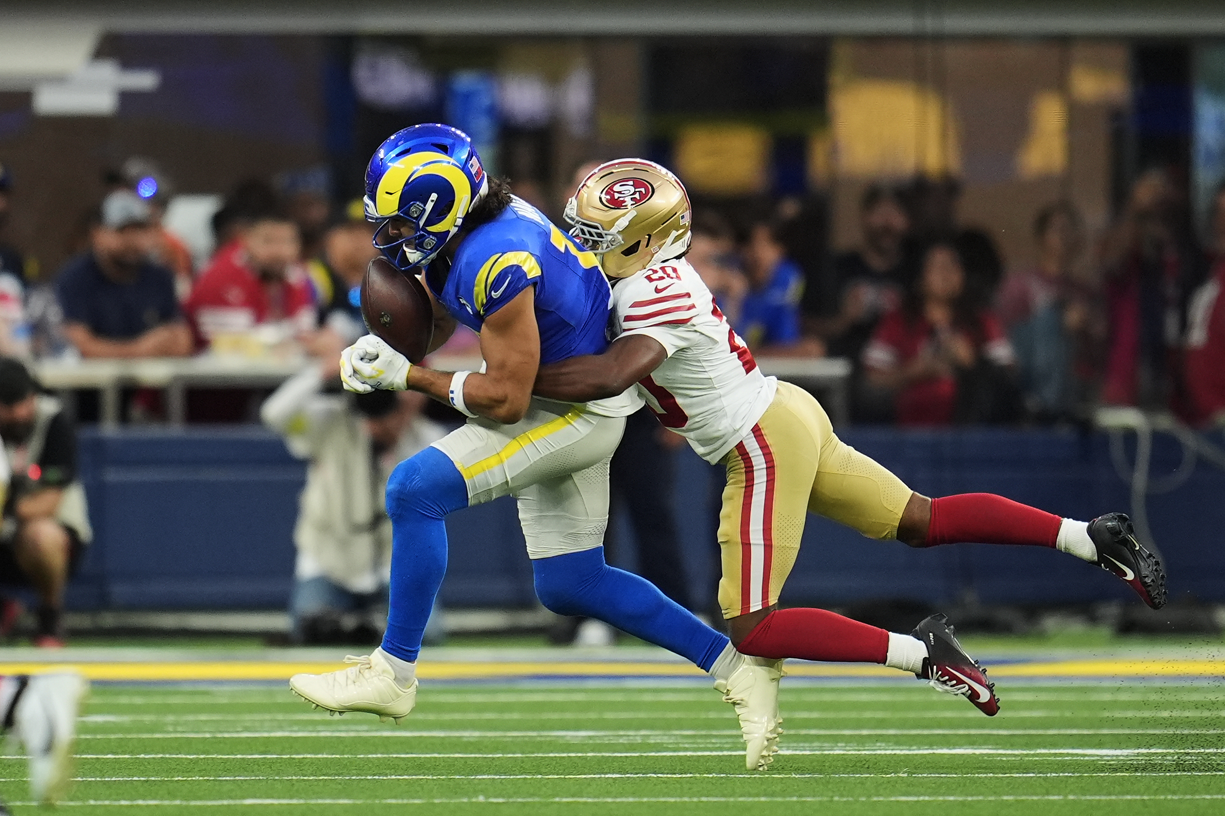 Rams wide receiver Puka Nacua, left, catches a pass against...