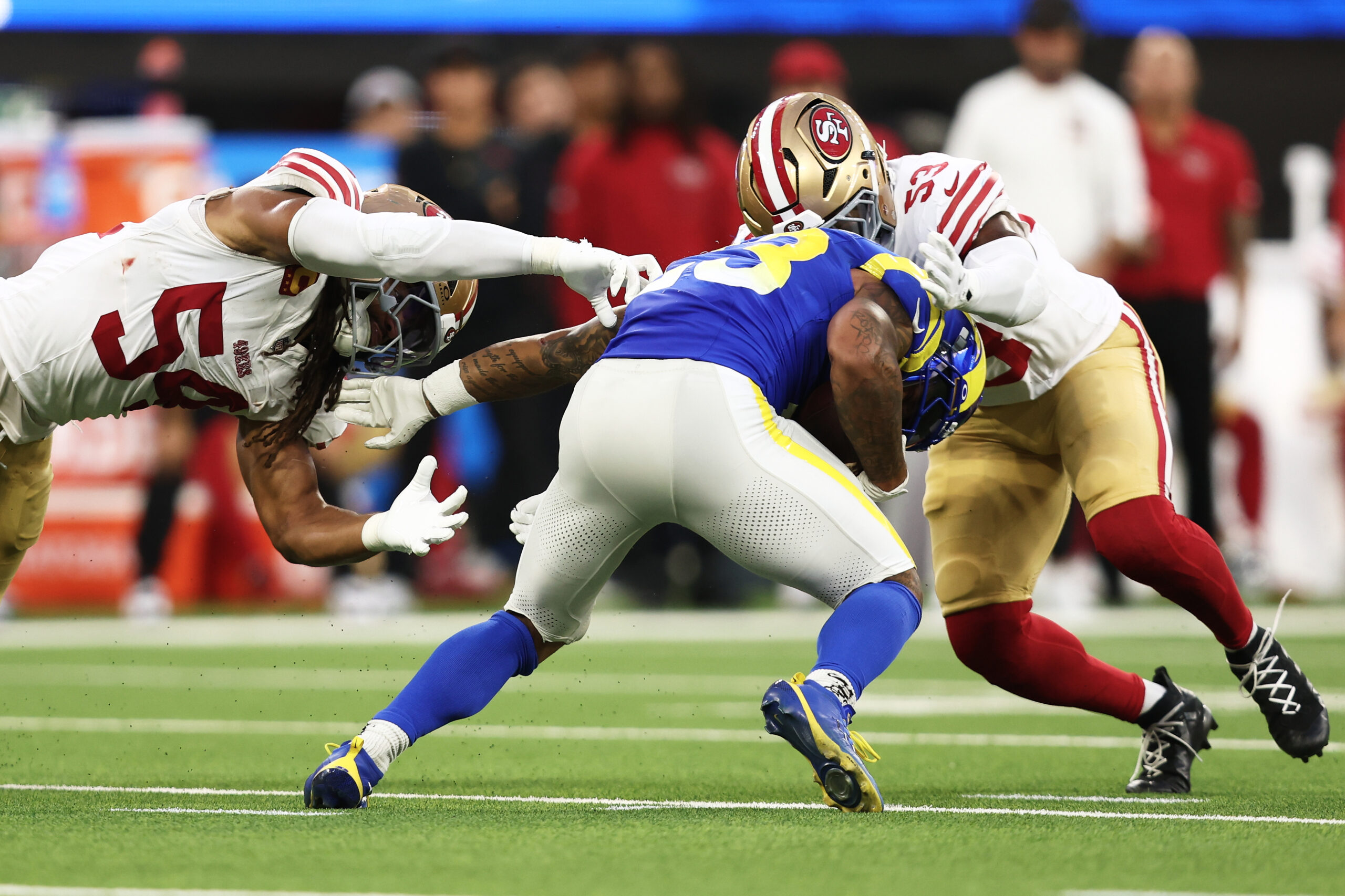 San Francisco 49ers middle linebacker Fred Warner, left, and linebacker...