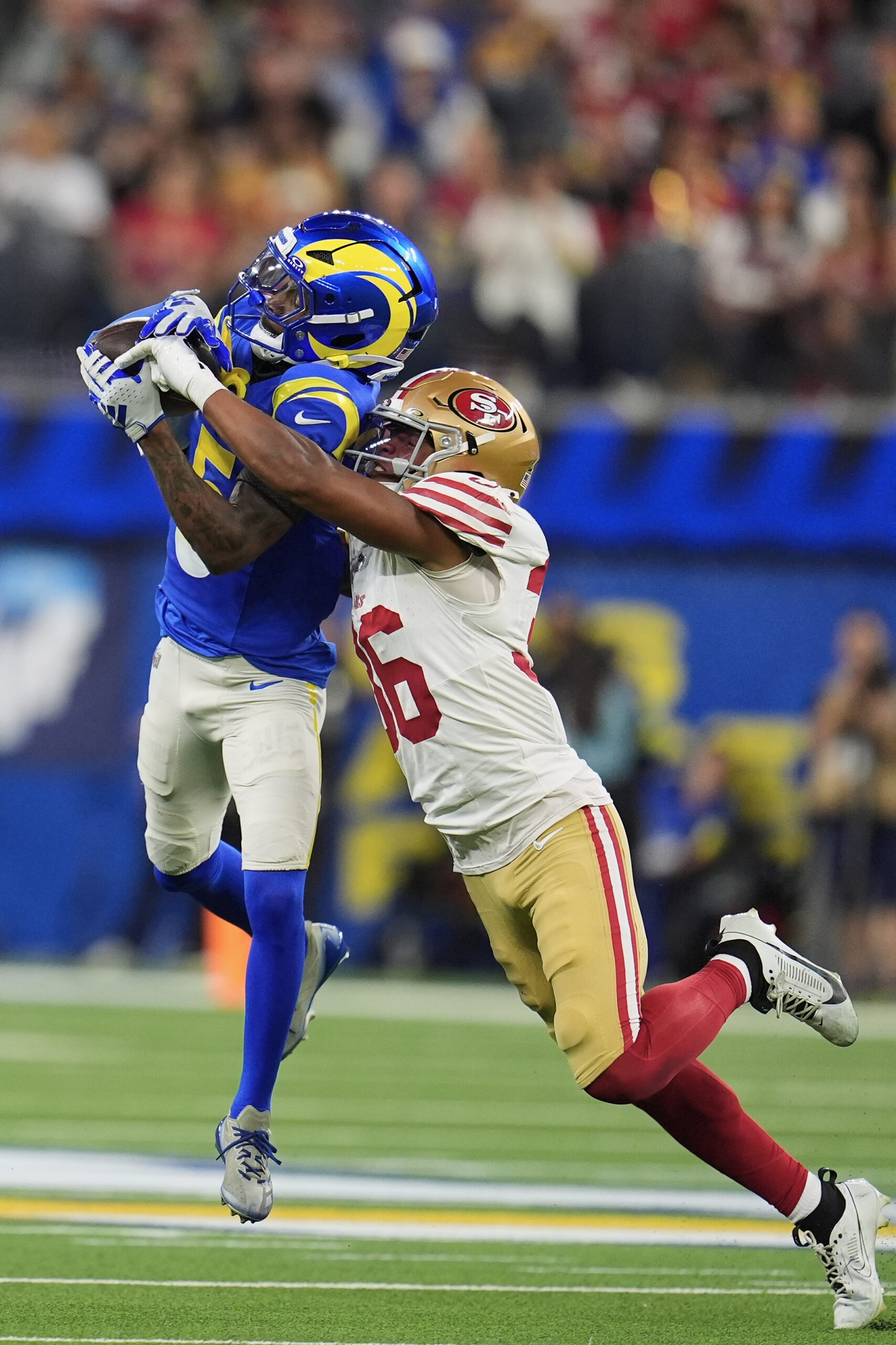 Rams wide receiver Tutu Atwell, left, catches a pass against...