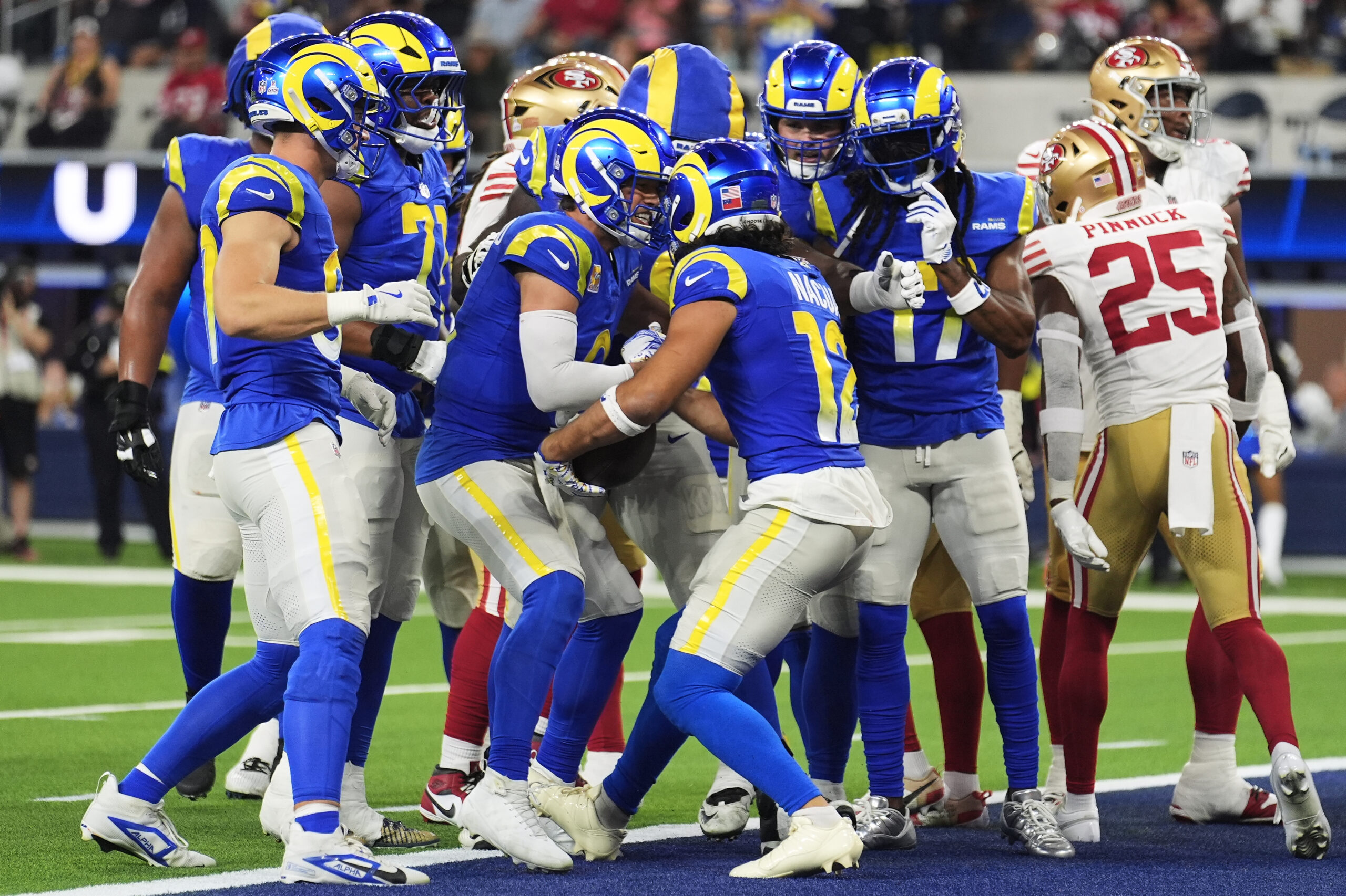 Rams quarterback Matthew Stafford, middle left, and wide receiver Puka...