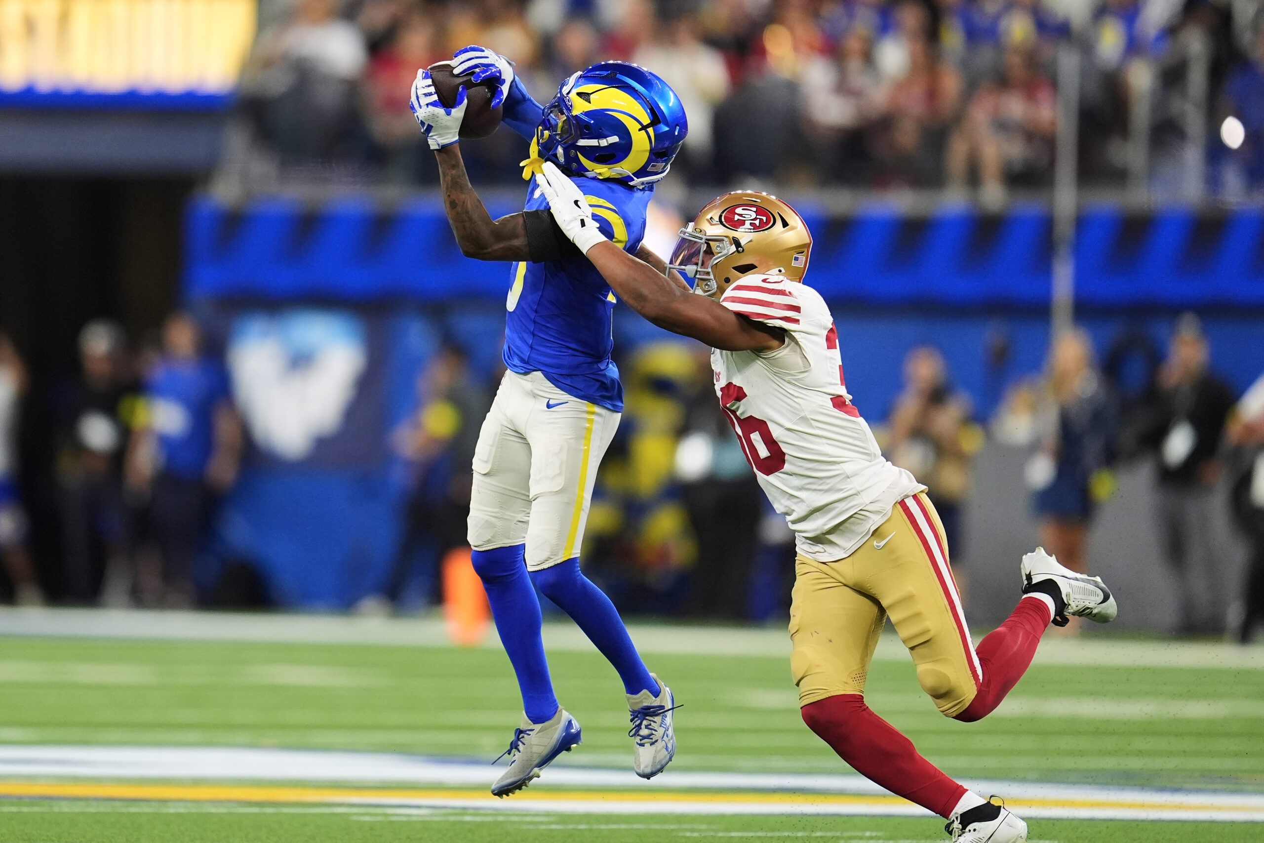 Rams wide receiver Tutu Atwell, left, catches a pass against...