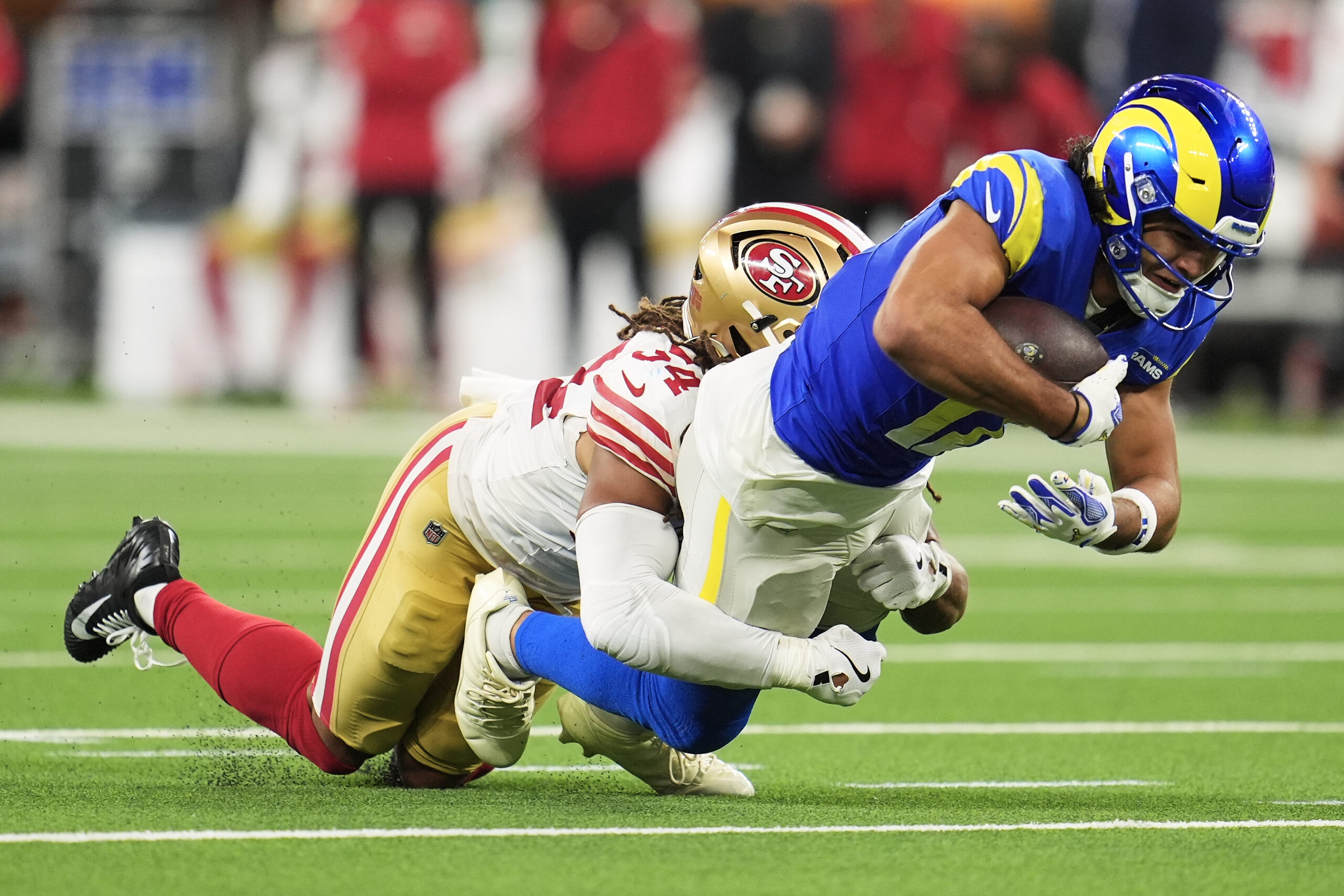 Rams wide receiver Puka Nacua, right, is tackled by San...
