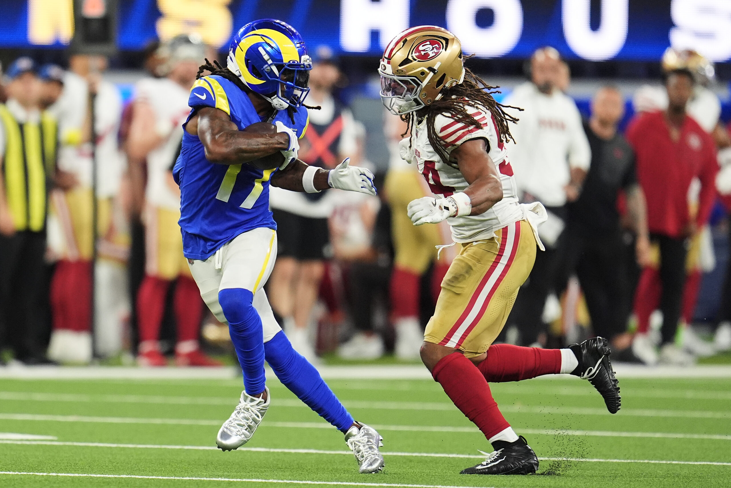 Rams wide receiver Davante Adams, left, runs after catching a...