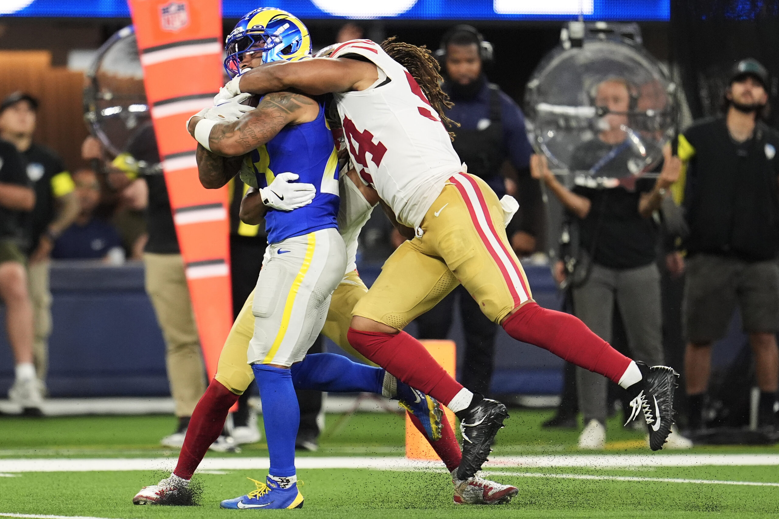 Rams running back Kyren Williams, left, runs against San Francisco...
