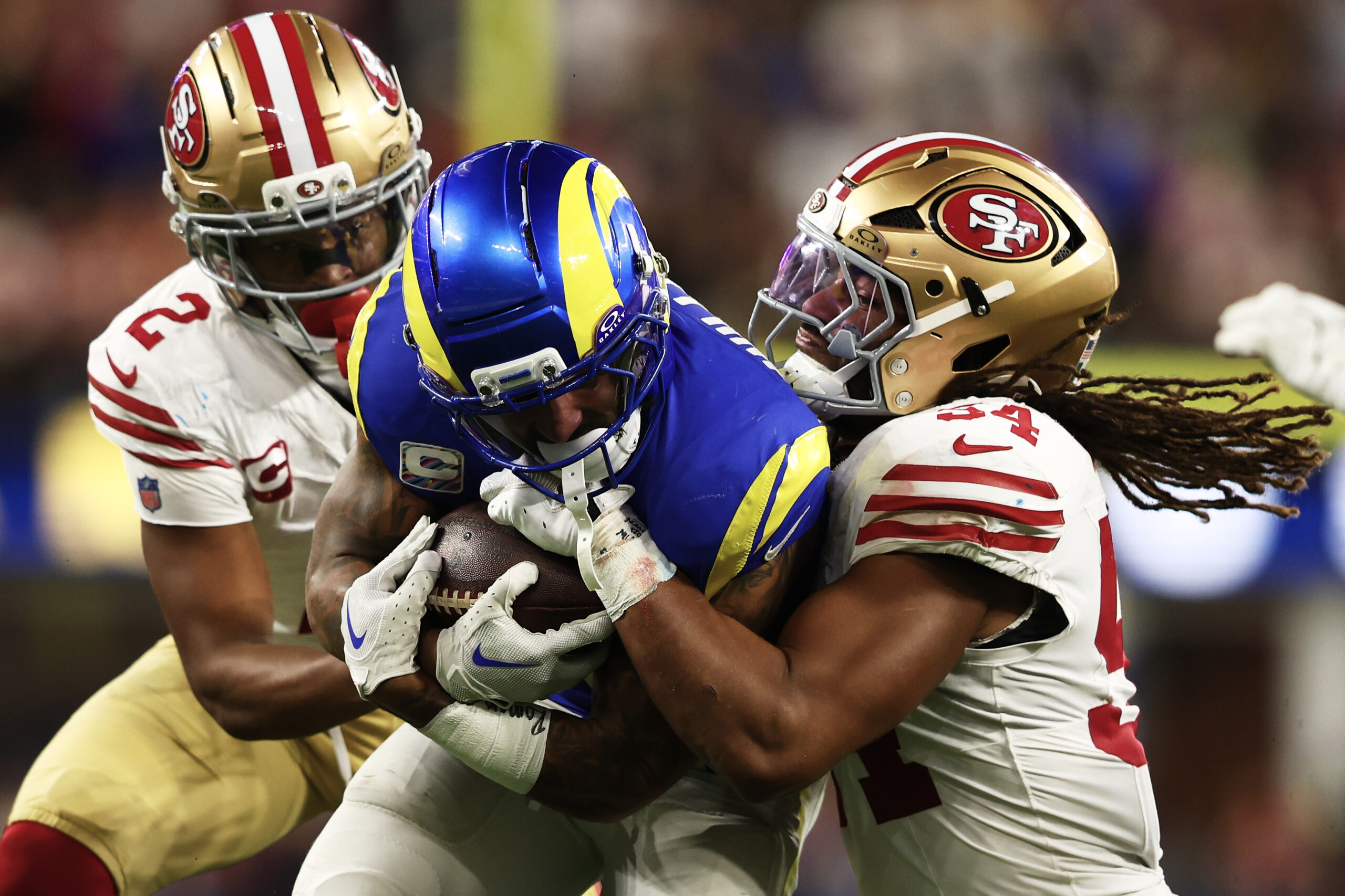 Rams running back Kyren Williams, middle, runs against San Francisco...