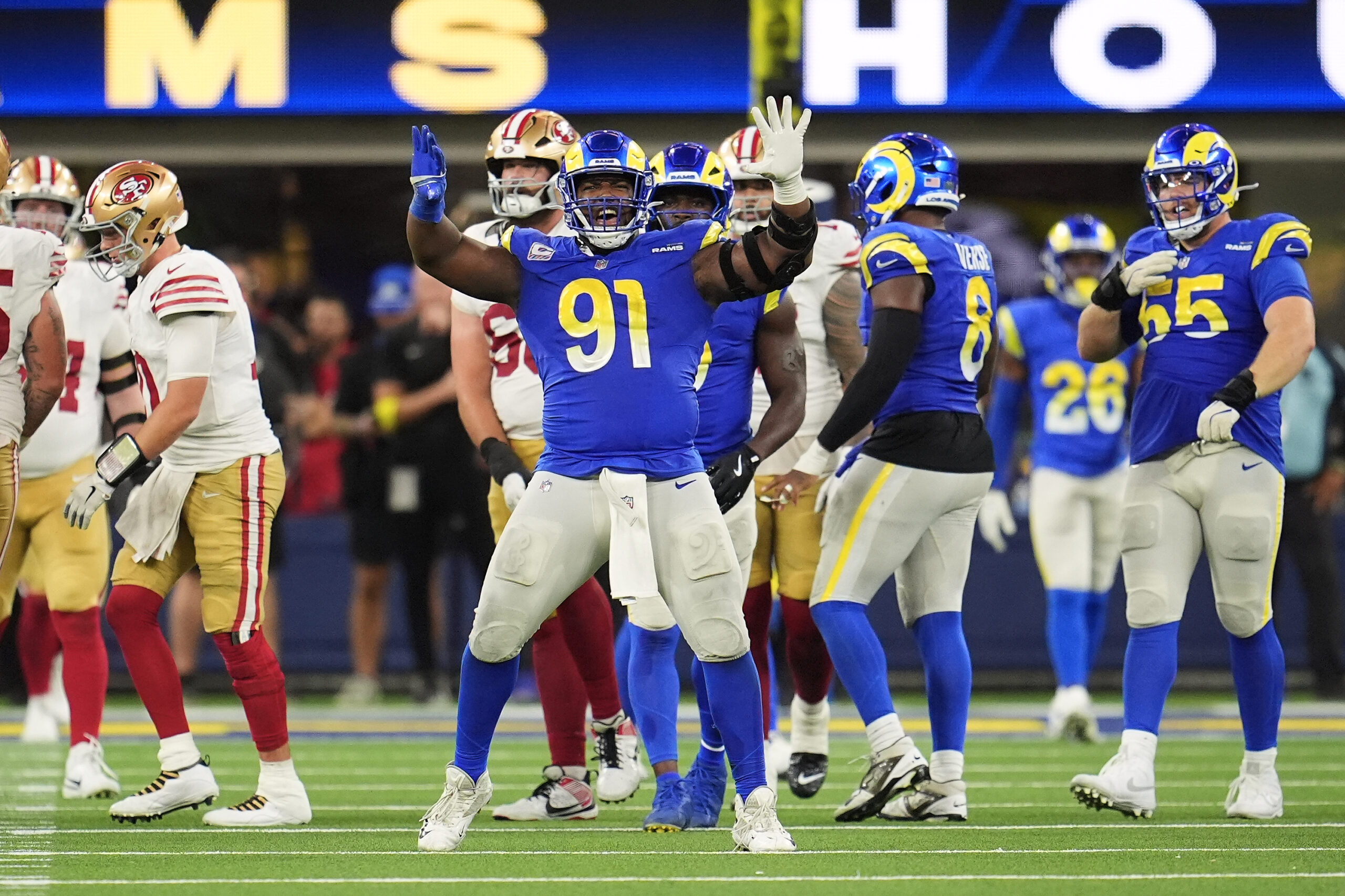 Rams defensive end Kobie Turner (91) celebrates during overtime of...