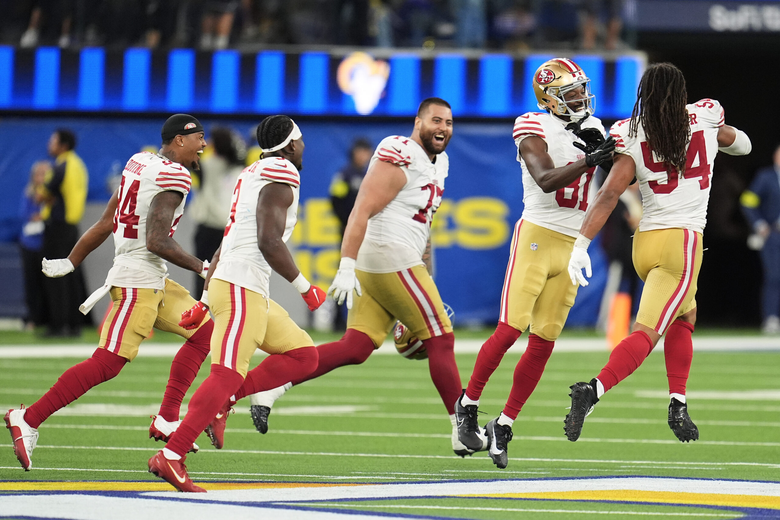San Francisco 49ers players celebrate after defeating the Rams in...