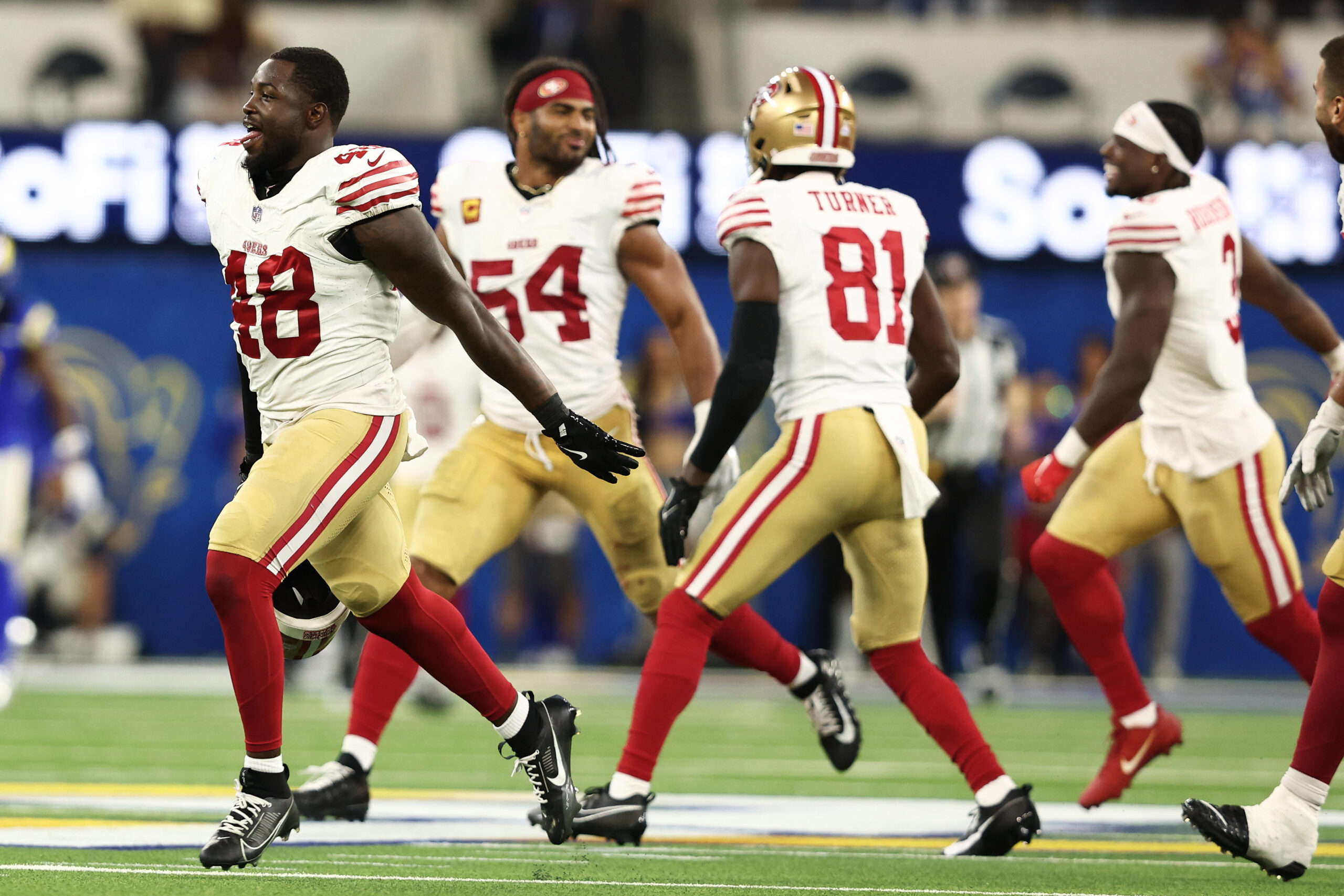San Francisco 49ers players celebrate after defeating the Rams in...