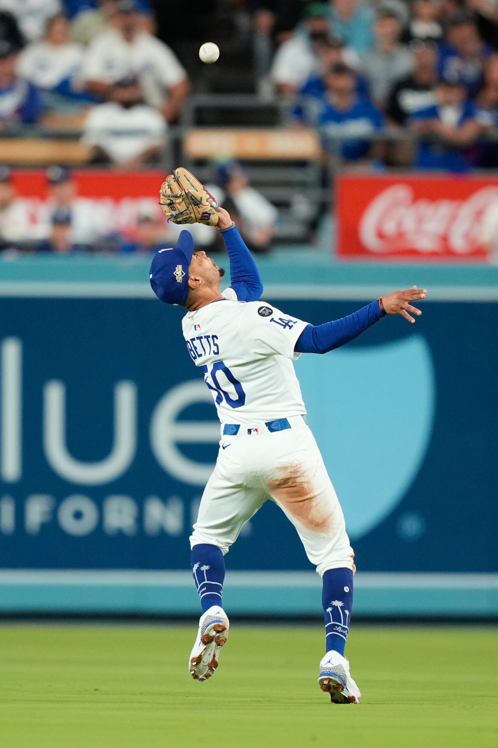 Dodgers shortstop Mookie Betts makes an over the shoulder catch...