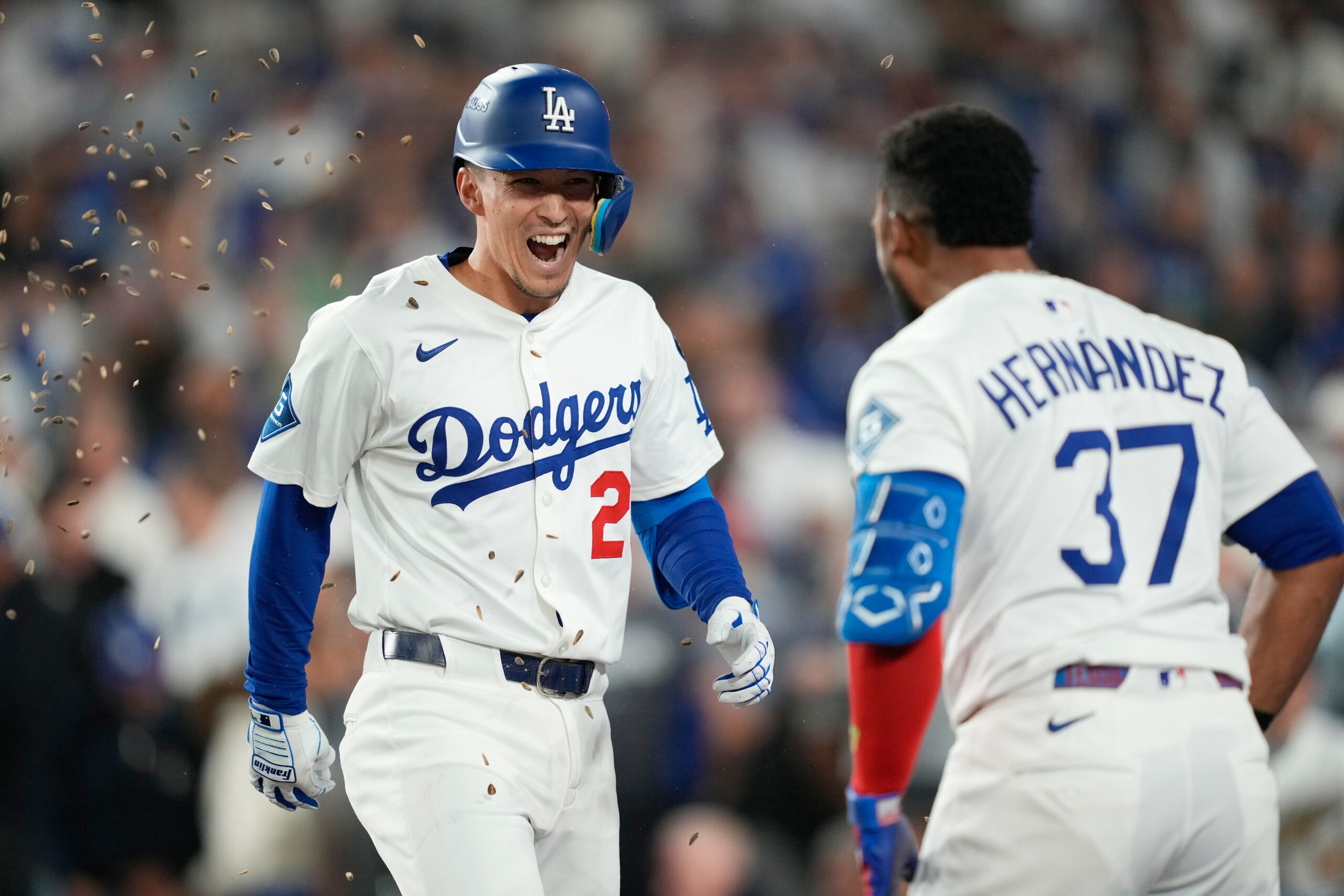 The Dodgers’ Tommy Edman, left, celebrates his solo home run...