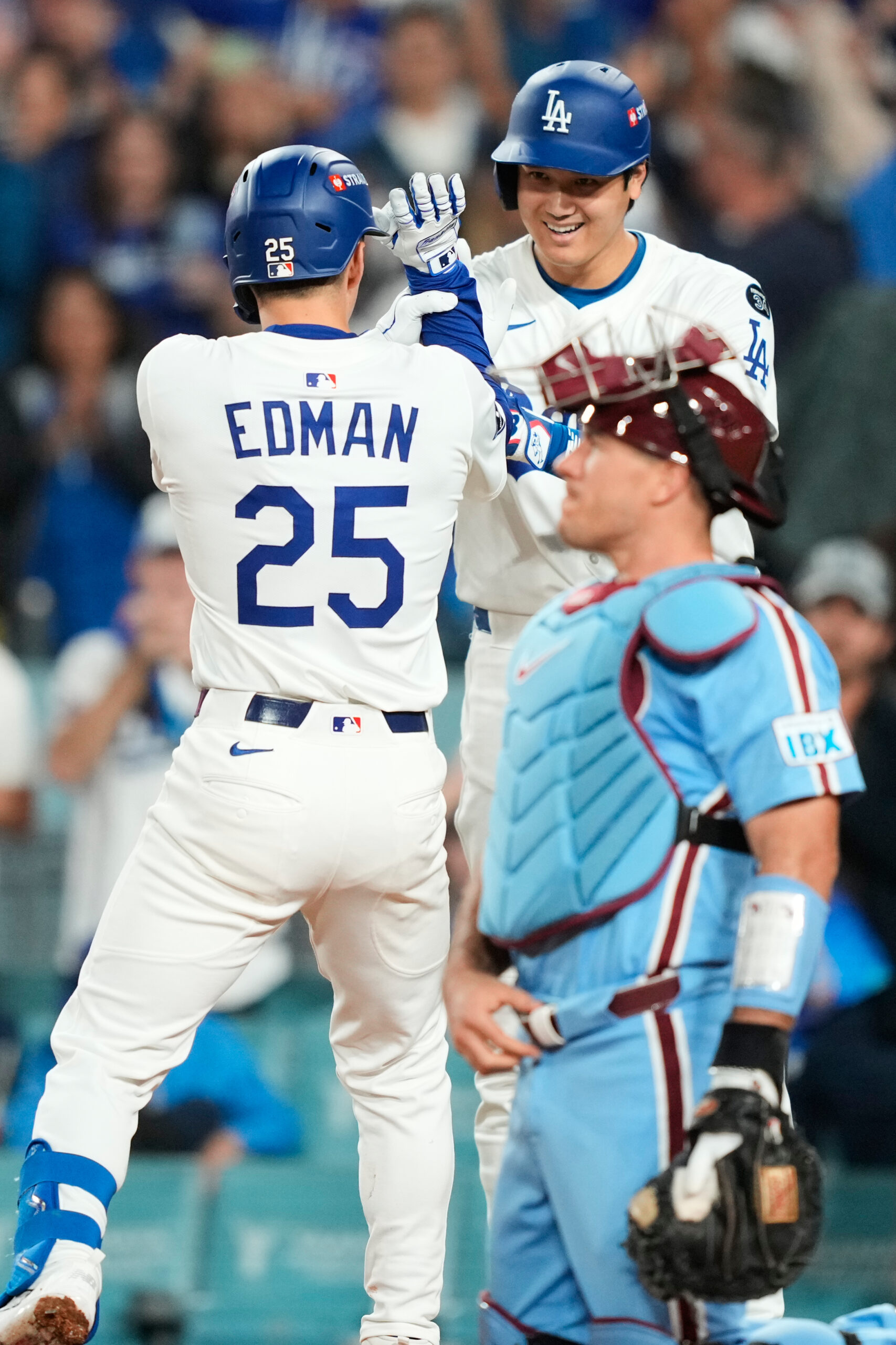 The Dodgers’ Tommy Edman, left, celebrates his solo home run...
